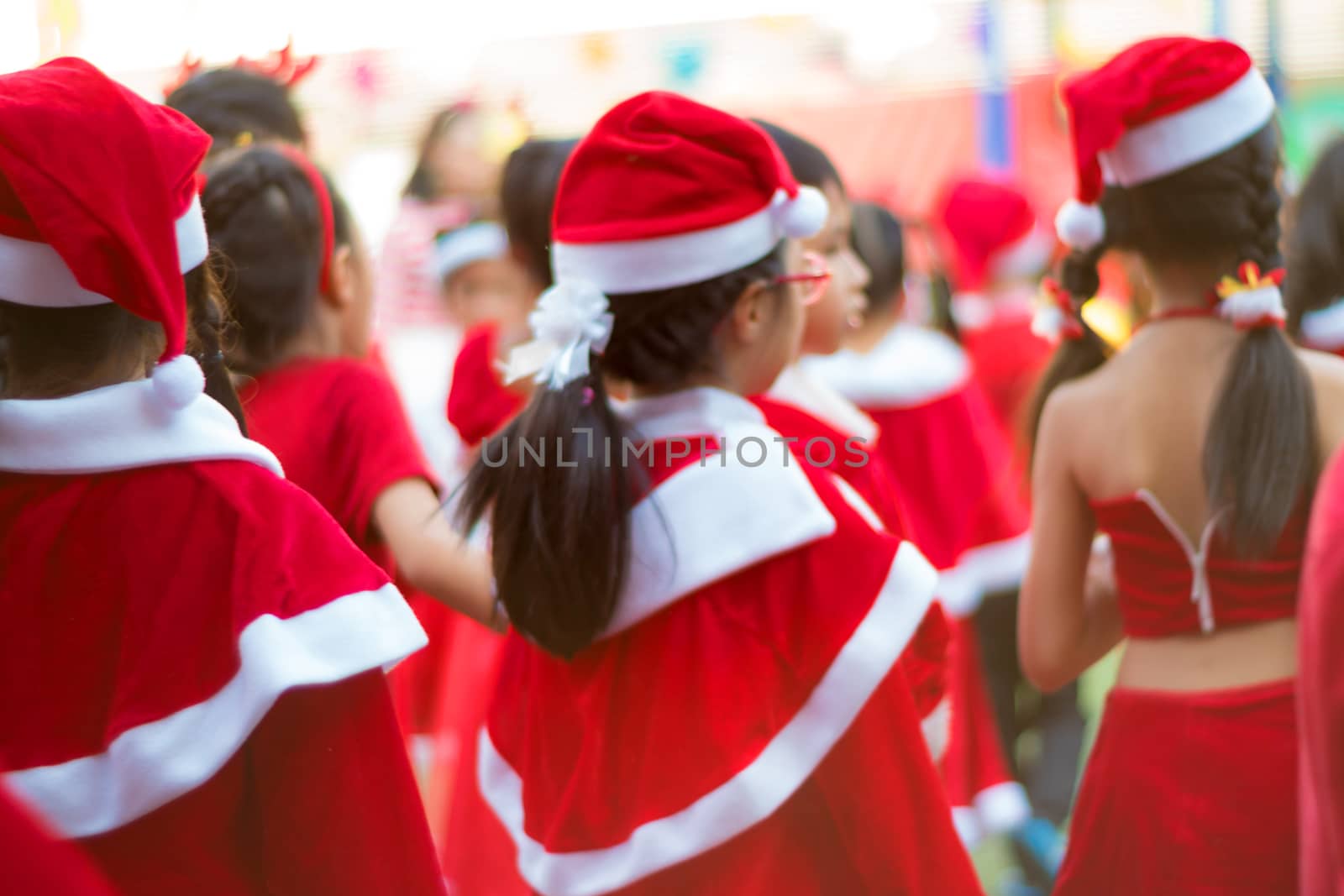 Girls in red theme costume in Christmas party of elementary school