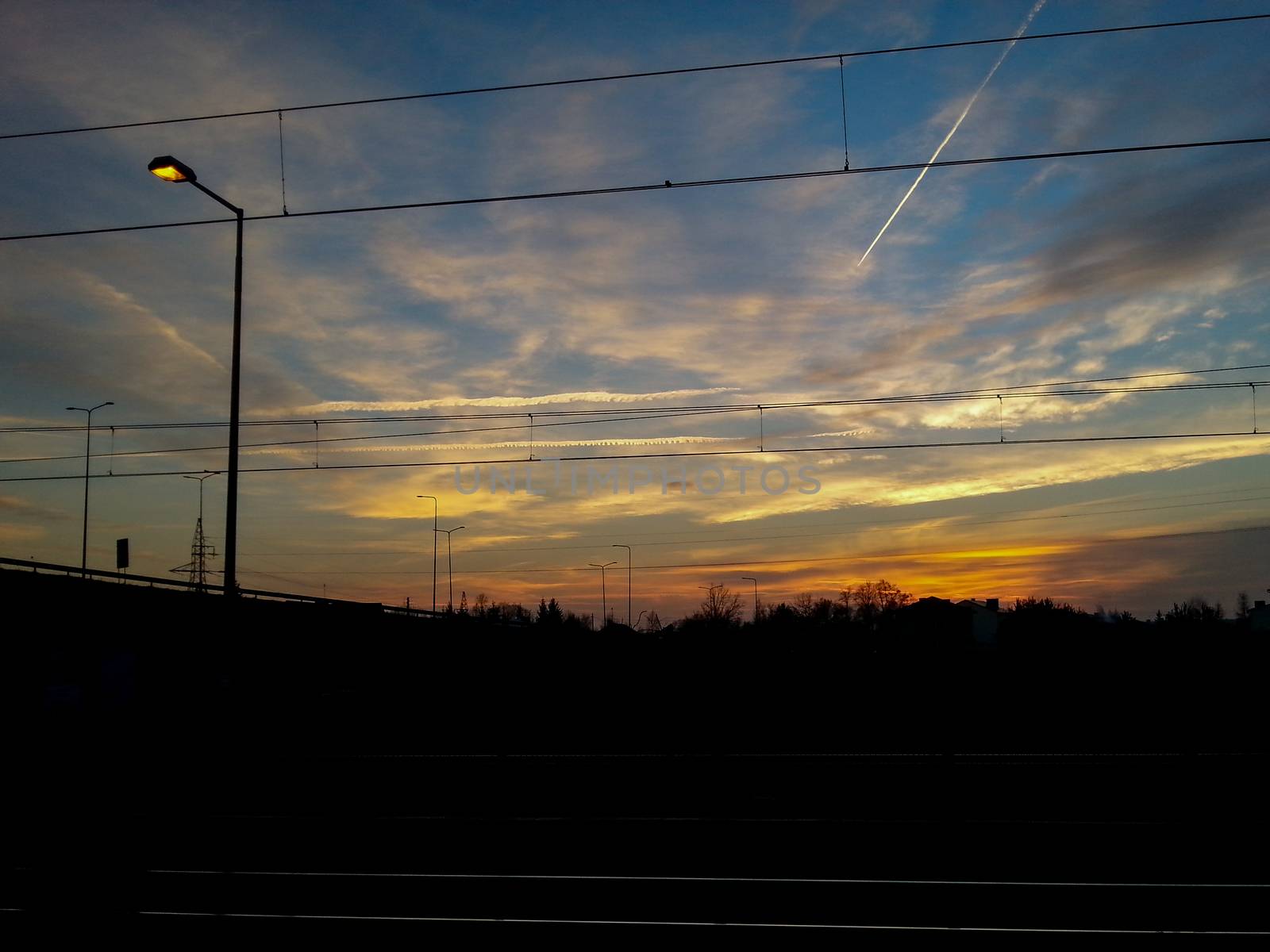 Sunset over silhouette of cityscape in Zawiercie city