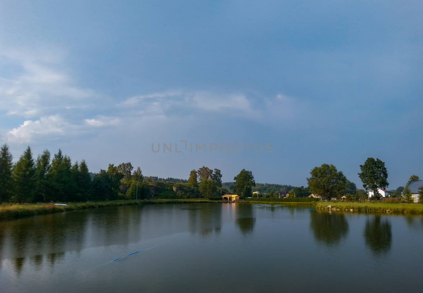 Summer landscape with lake and trees in stormy day