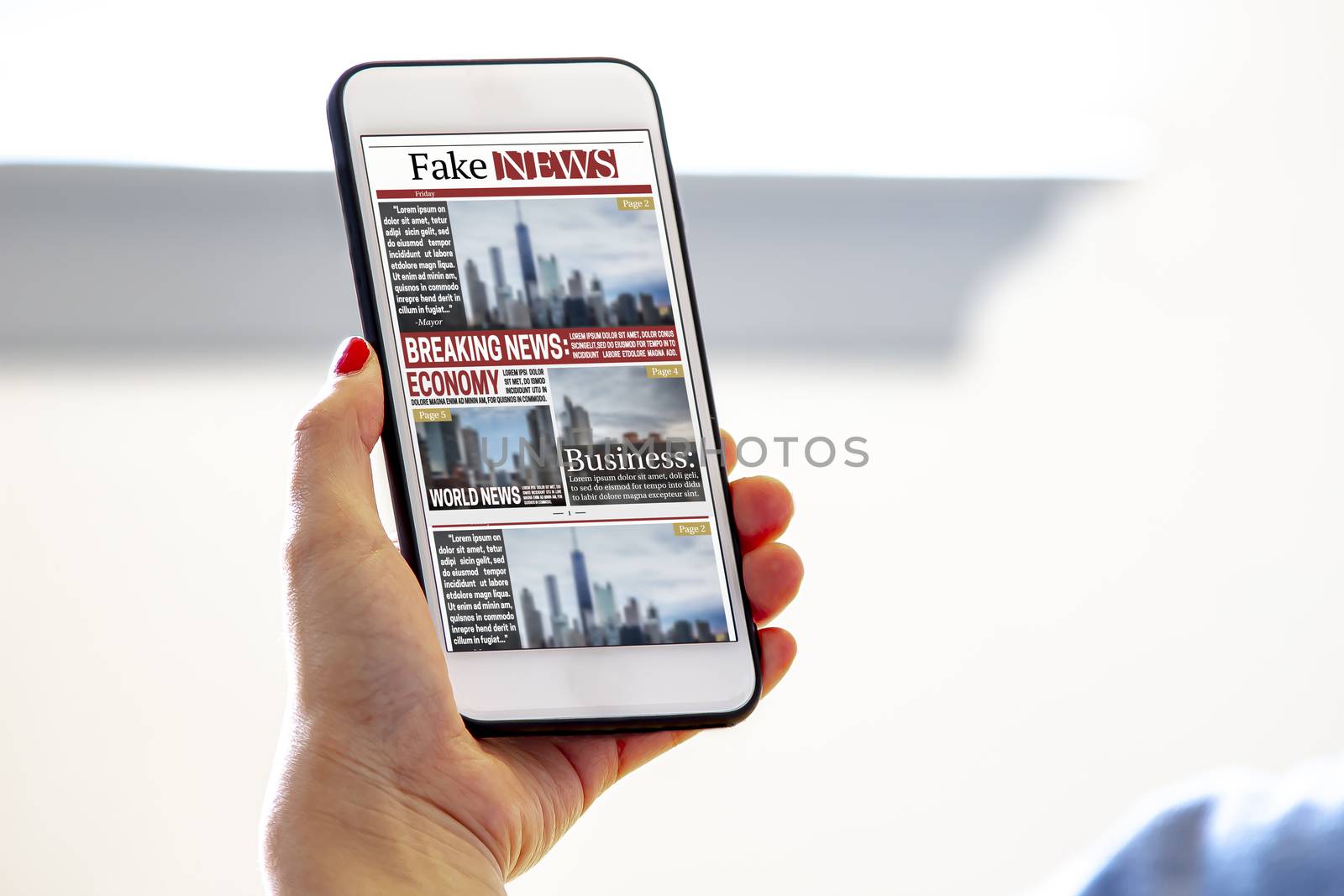 A female holding a smart phone reading fake news