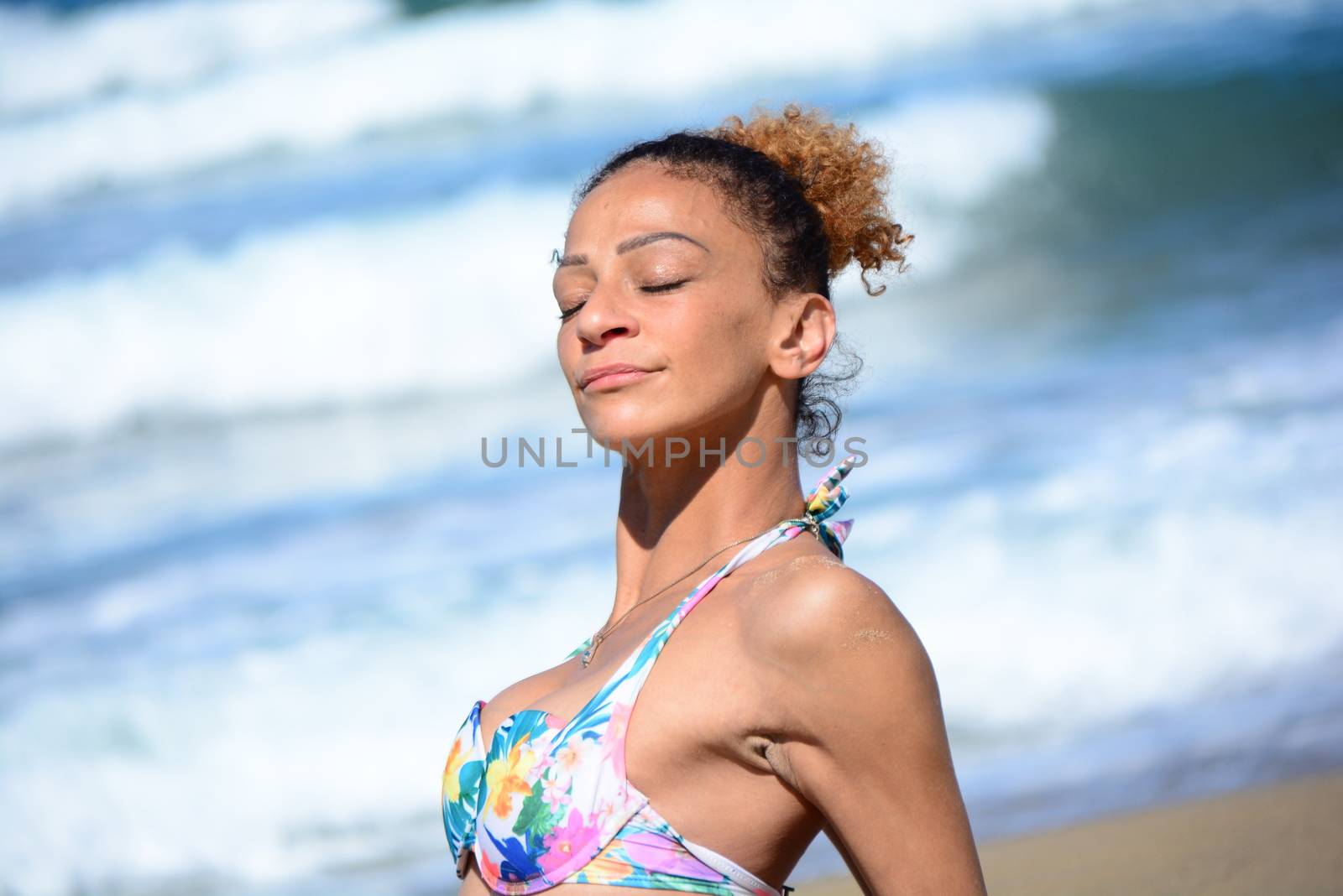 Photo shoot on the beach of a middle-aged woman in a sunny day