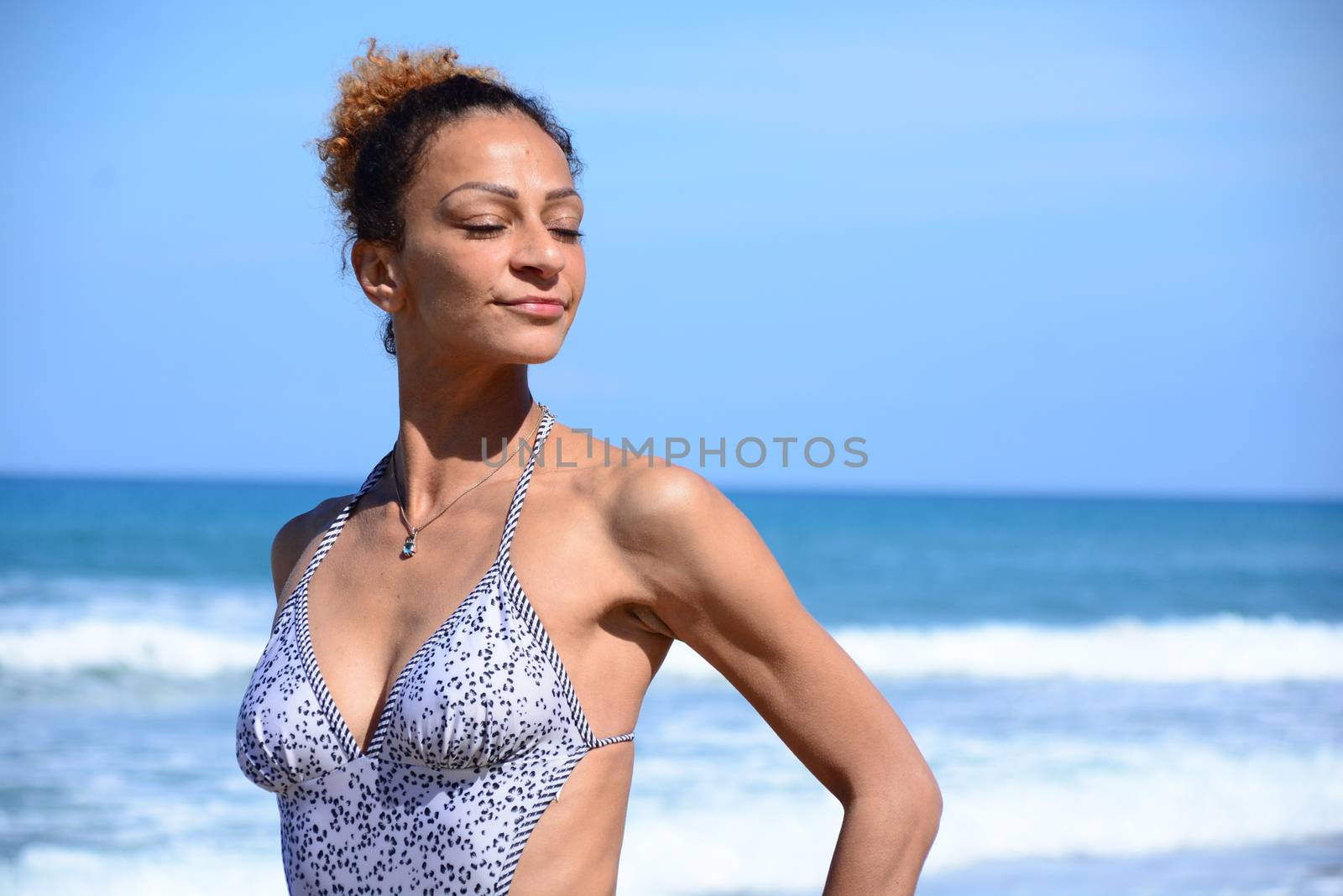 Photo shoot on the beach of a middle-aged woman in a sunny day