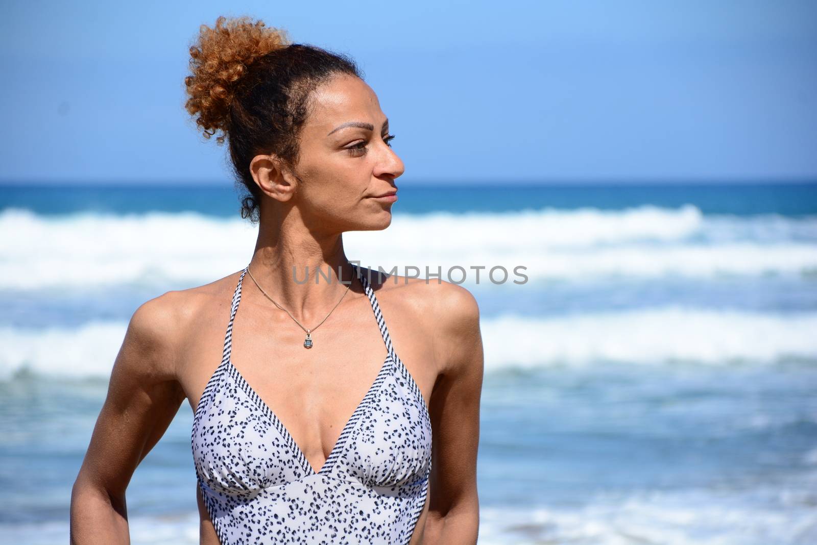 Photo shoot on the beach of a middle-aged woman in a sunny day
