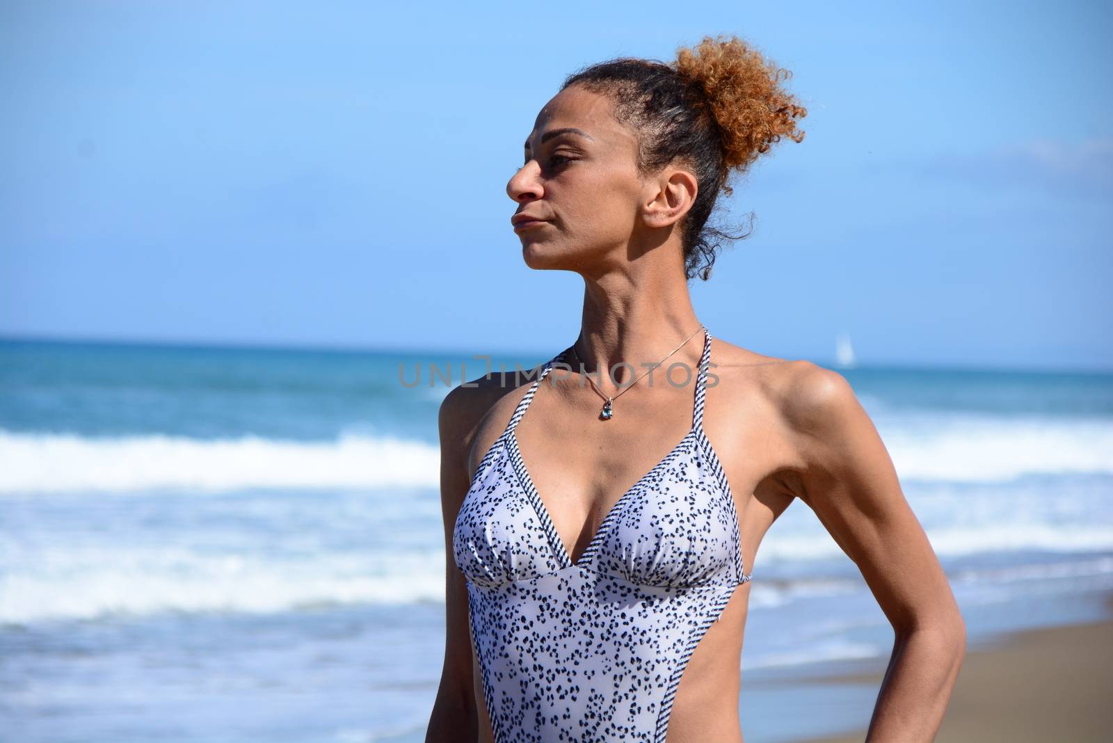 Photo shoot on the beach of a middle-aged woman in a sunny day