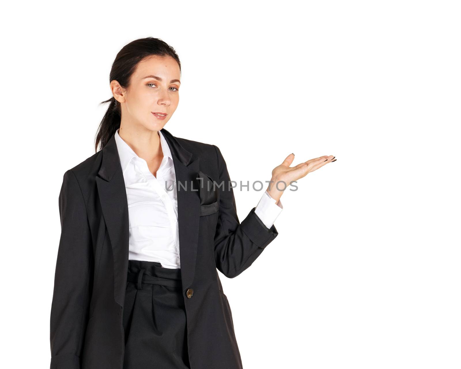 A business woman in white shirt and  black suit, smiling and branding to the left to recommend a worthwhile real estate project. Portrait on white background with studio light.