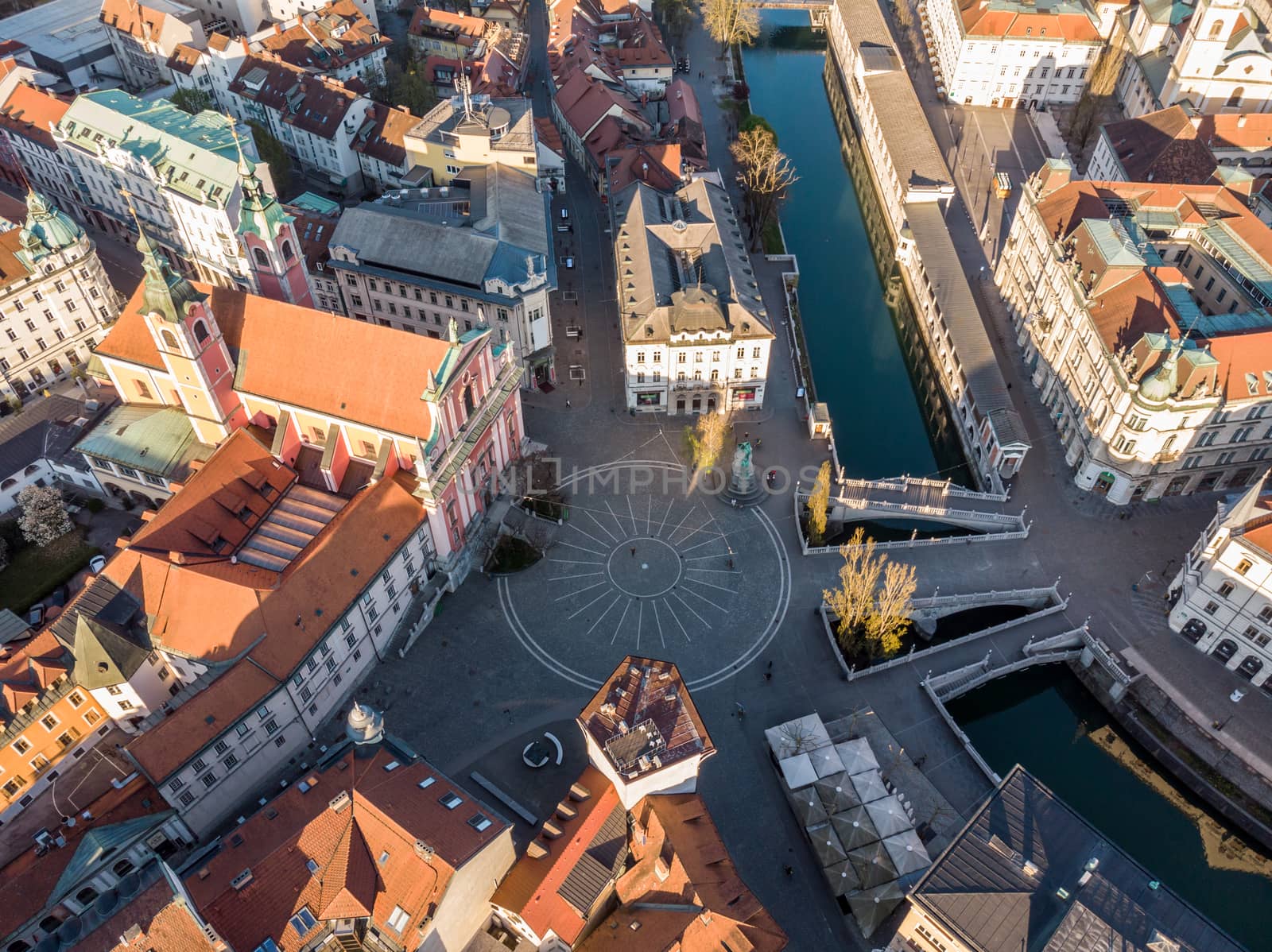 Aerial drone view of Preseren Squere and Triple Bridge over Ljubljanica river,Tromostovje, Ljubljana, Slovenia. Empty streets during corona virus pandemic social distancing measures.