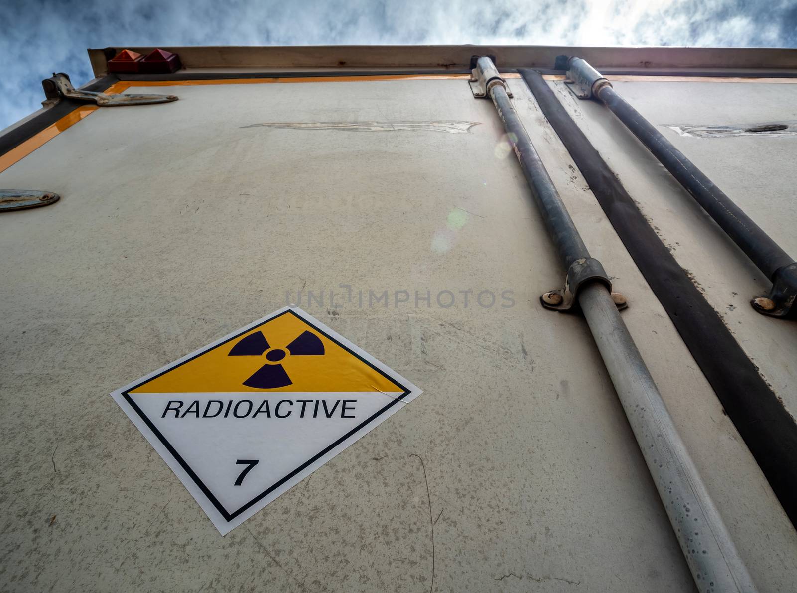 Radiation warning sign on the Hazardous materials transport label Class 7 at the aluminum container of transport truck
