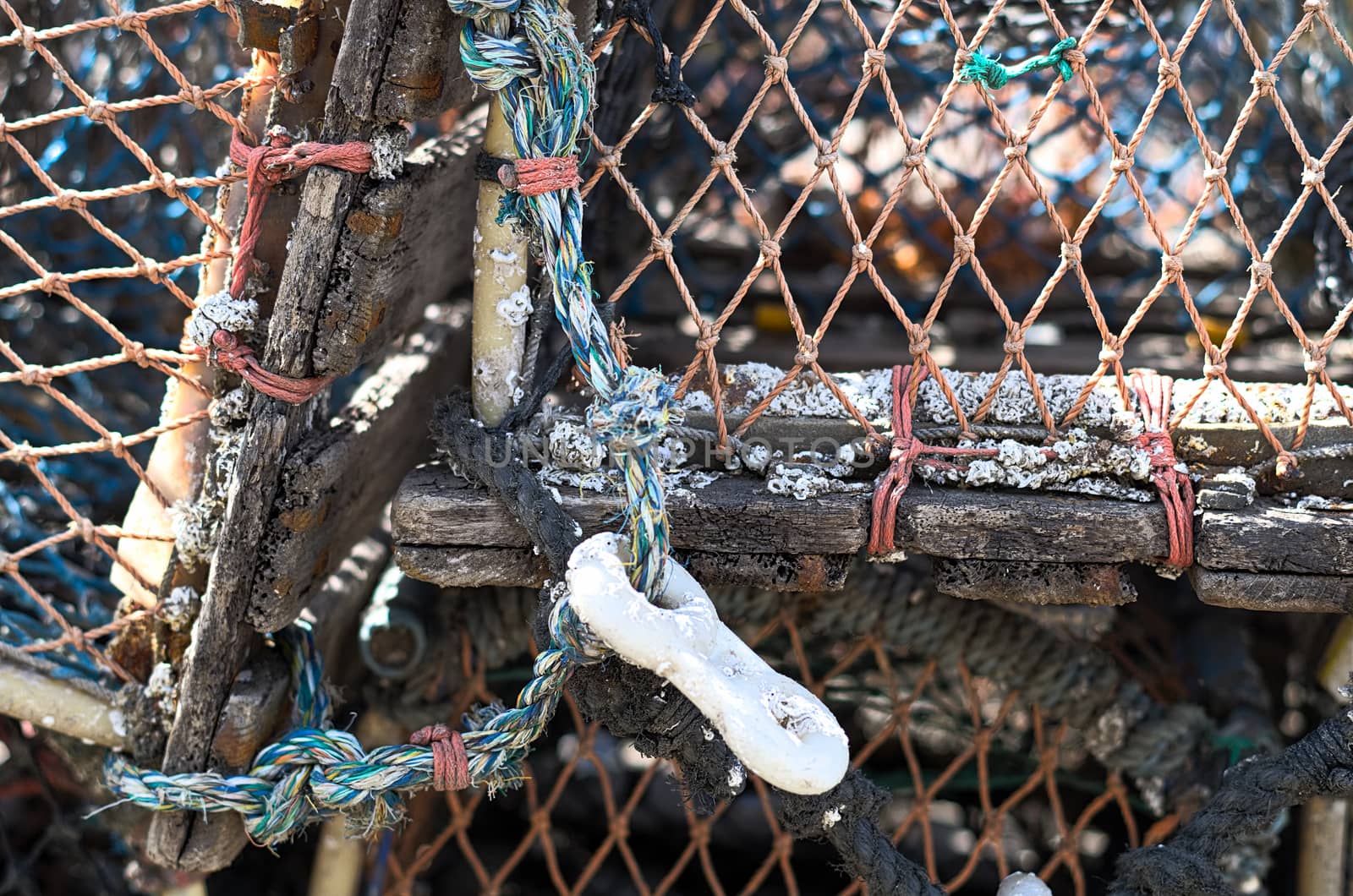 Detail of lobster pots sitting in the bay of the pretty fishing village of Staithes in North Yorkshire