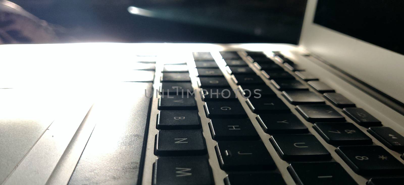 Macro shot of laptop keypads basking in the pure light of the morning sun. by mshivangi92