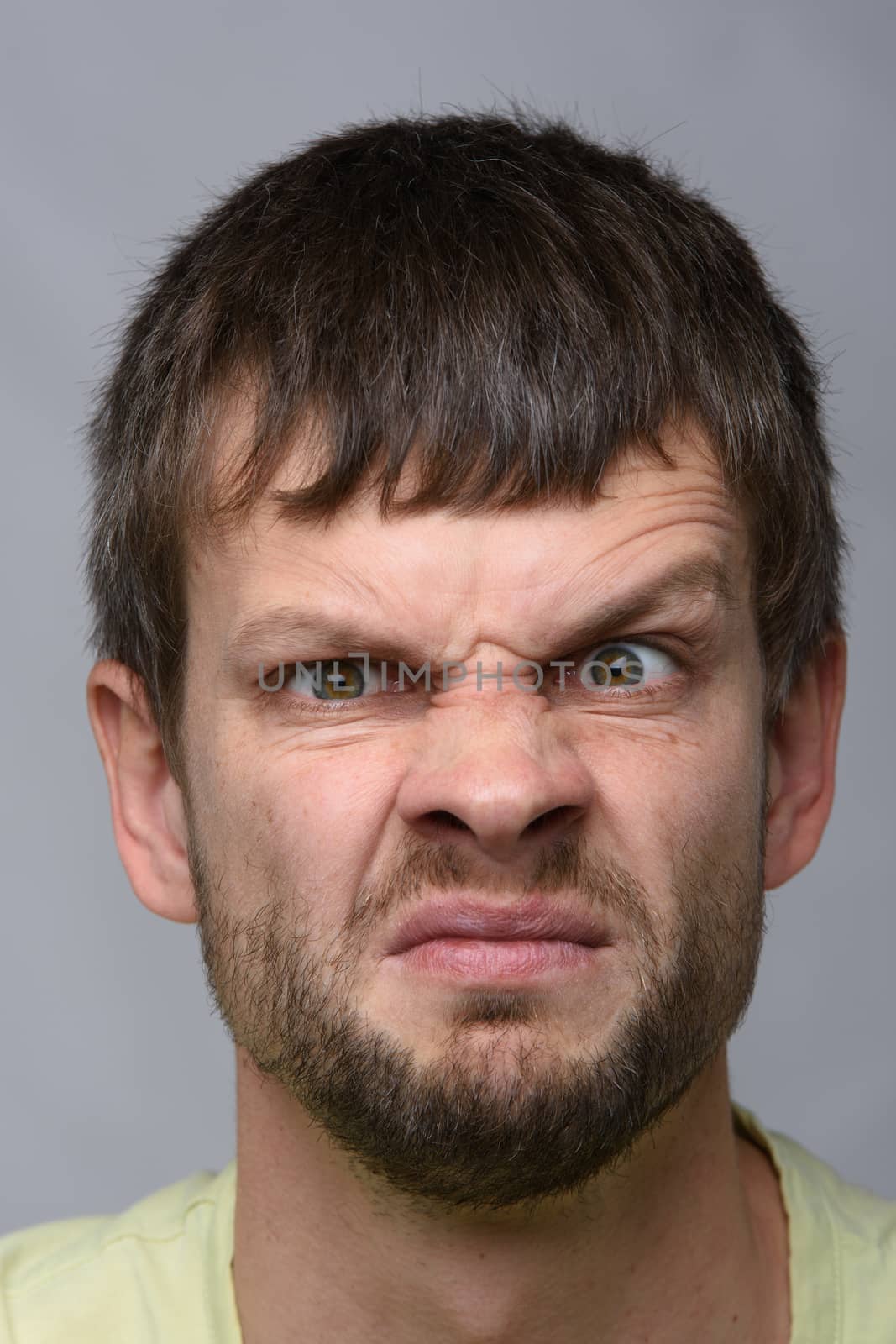 Close-up portrait of a man funny frowning eyebrow of European appearance