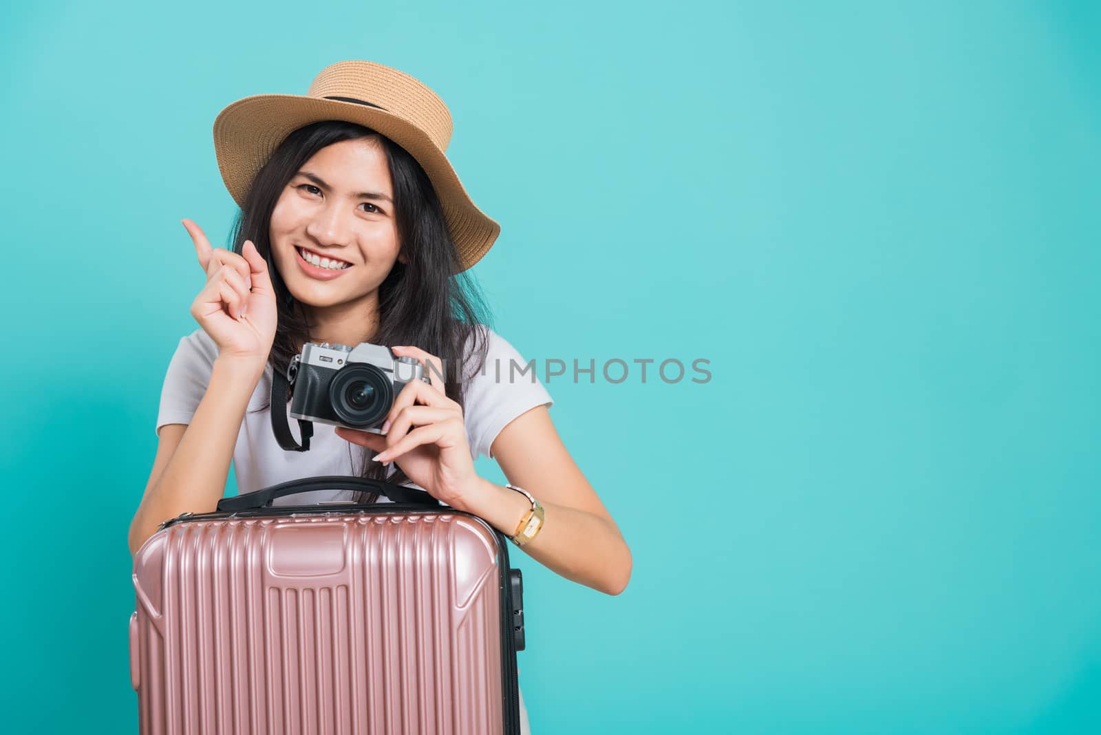 woman wear white t-shirt her holding suitcase bag and photo mirr by Sorapop