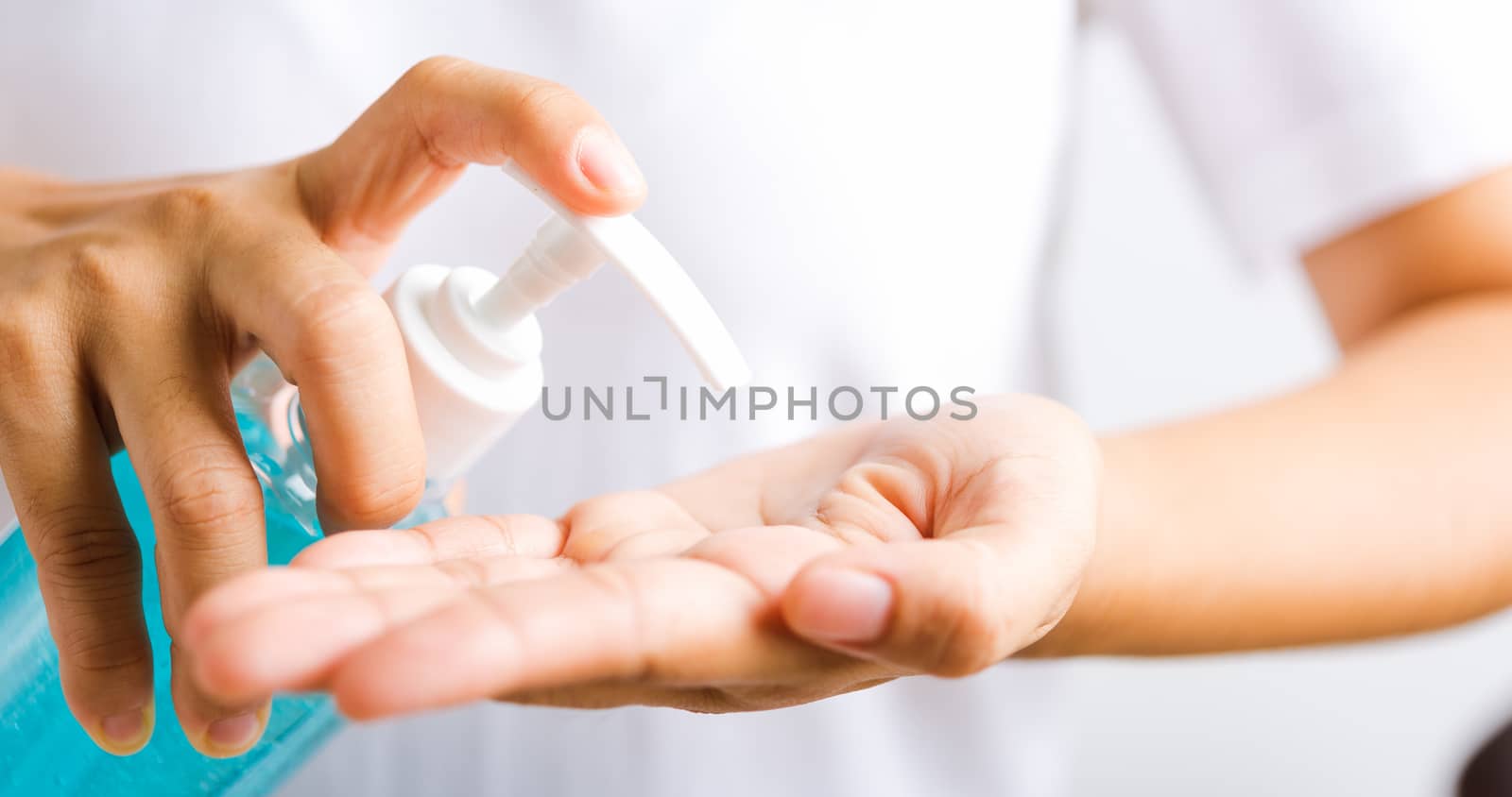 Closeup Hand Asian young woman applying pump dispenser sanitizer alcohol gel on hand wash cleaning, hygiene prevention COVID-19 or coronavirus protection concept, isolated on white background