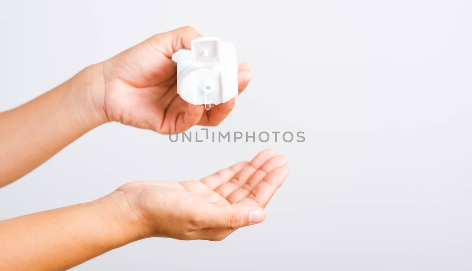 Closeup Hand Asian young woman applying drop dispenser sanitizer alcohol gel on hand wash cleaning, hygiene prevention COVID-19 or coronavirus protection concept, isolated on white background