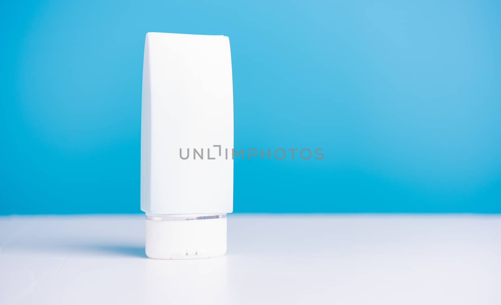 Plastic dispenser sanitizer alcohol gel bottle for washing hand hygiene prevention of coronavirus virus studio shot on blue background