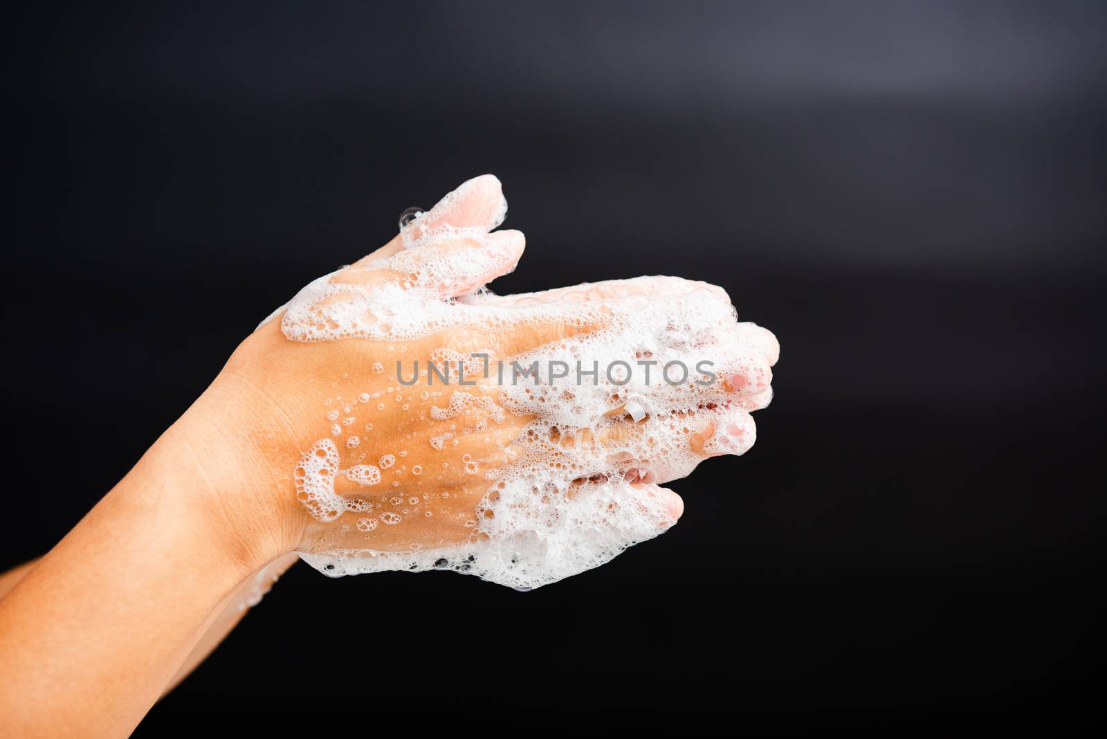 Closeup body care Asian young woman washing hands with soap have foam, hygiene prevention COVID-19 or coronavirus protection concept, isolated on black background