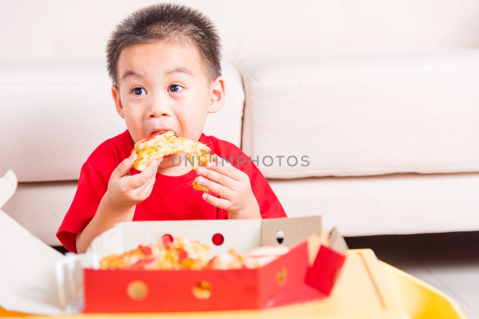 Hot Homemade, Vegetarian fast Italian food, Cute Little Child enjoying eating Delivery Pizza pepperoni, cheese many slices deliciously in an open cardboard box at home