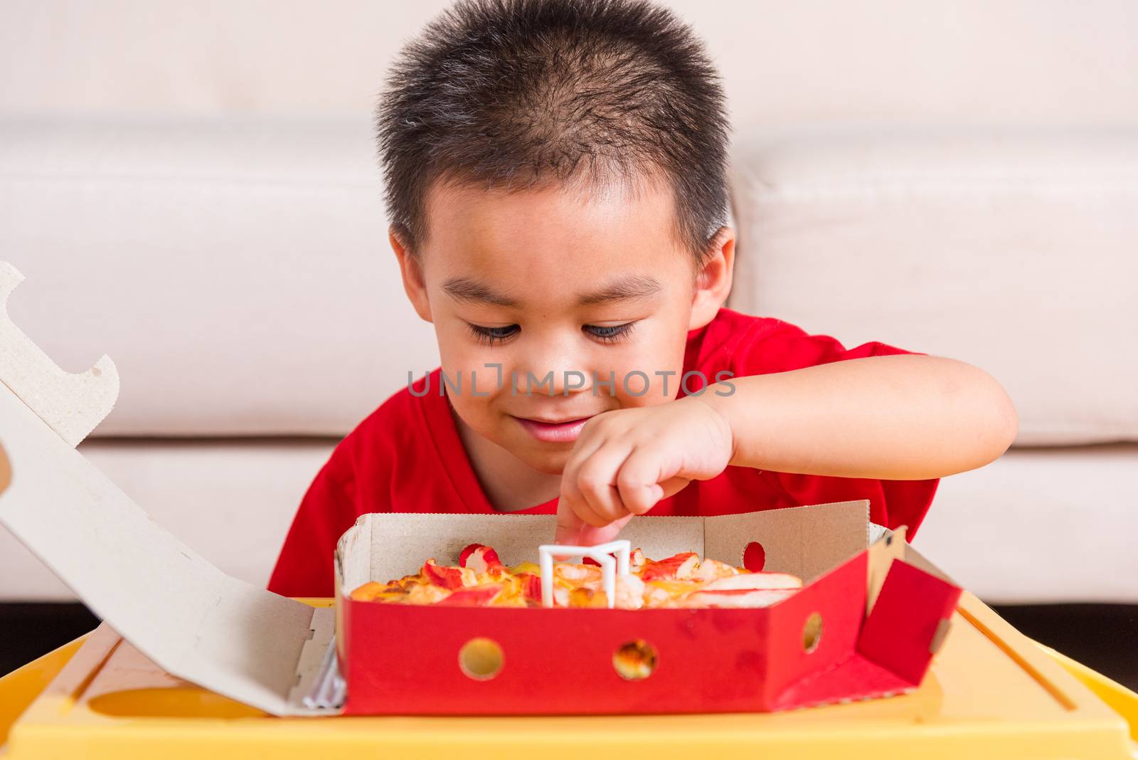 Little Child enjoying holding Delivery Pizza pepperoni, cheese by Sorapop