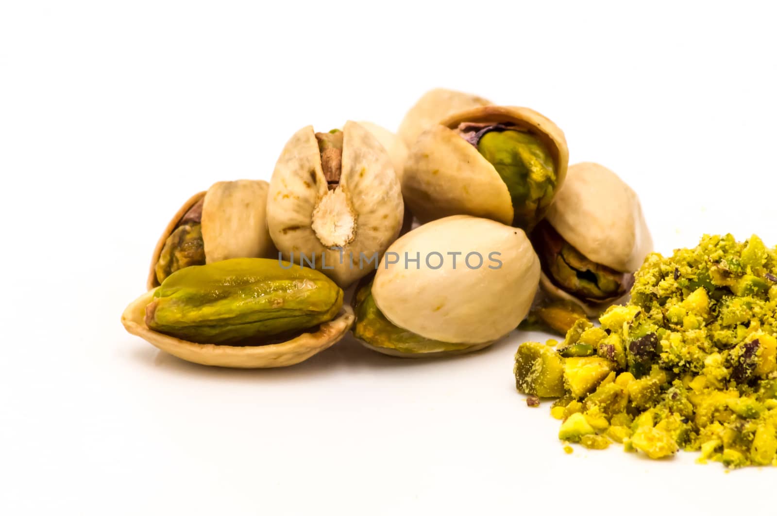 Pistachio isolated on white background, part of pounded pistachios, full depth of field