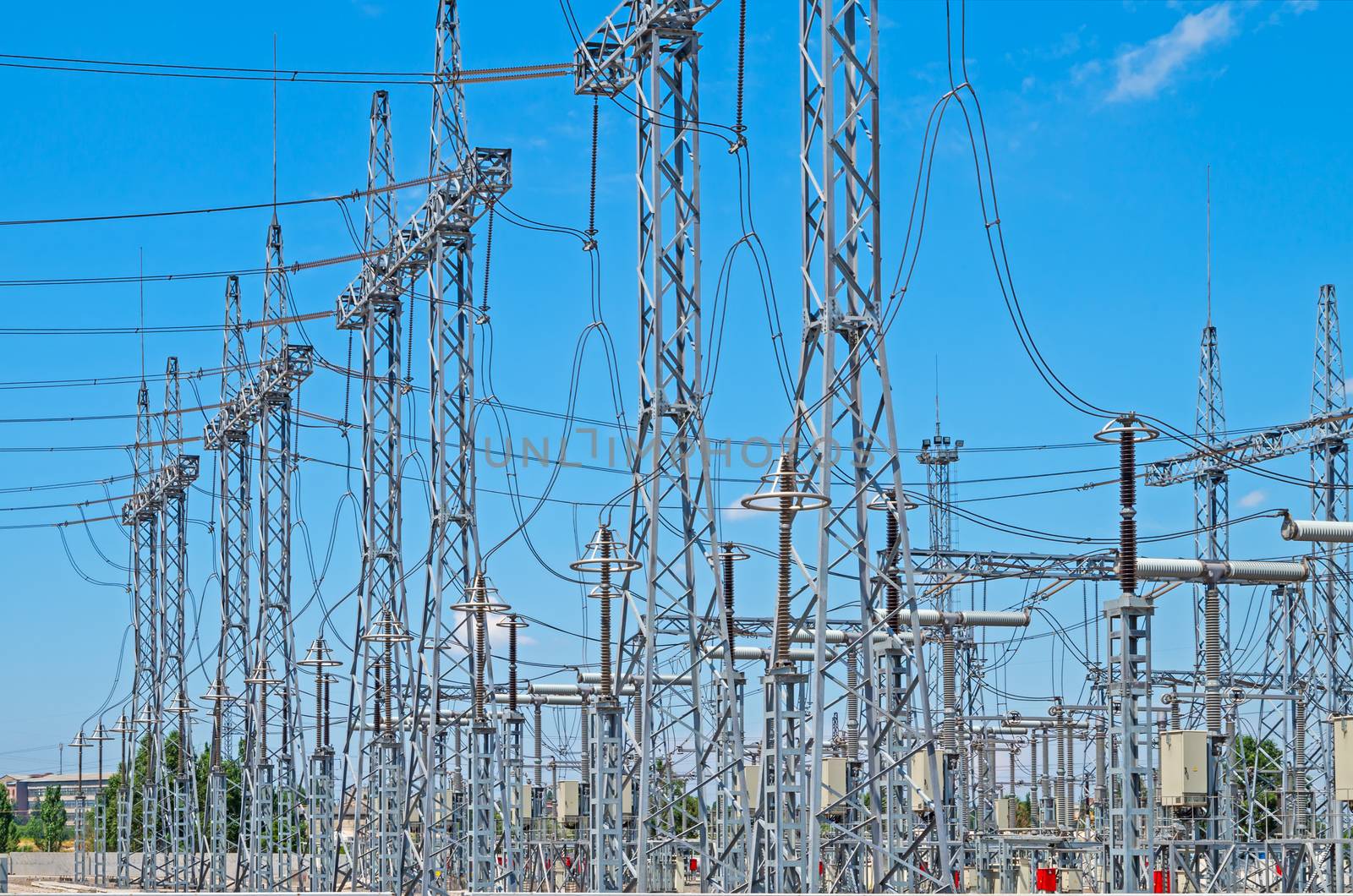 Image of high voltage transformer station against the blue sky.