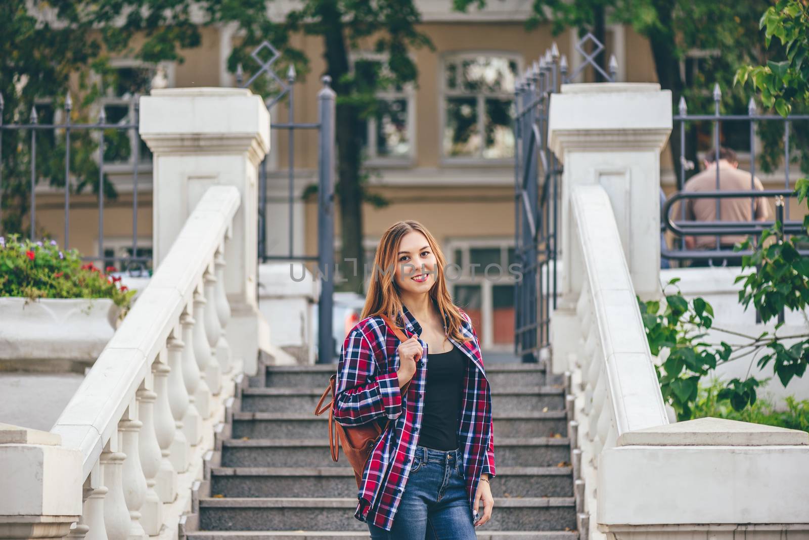 Smiling woman standing on the old staircase