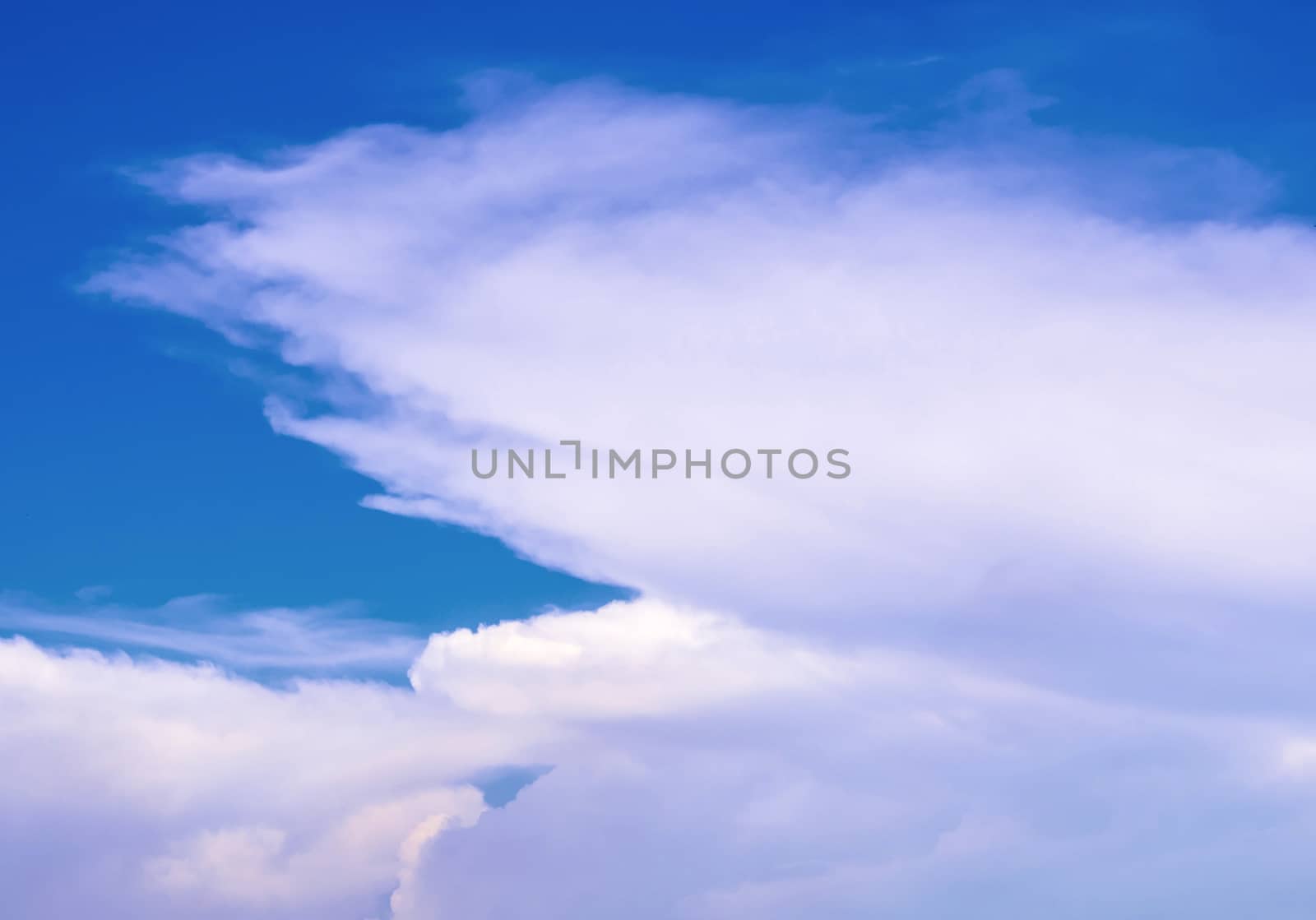 Fluffy clouds in the bright blue sky