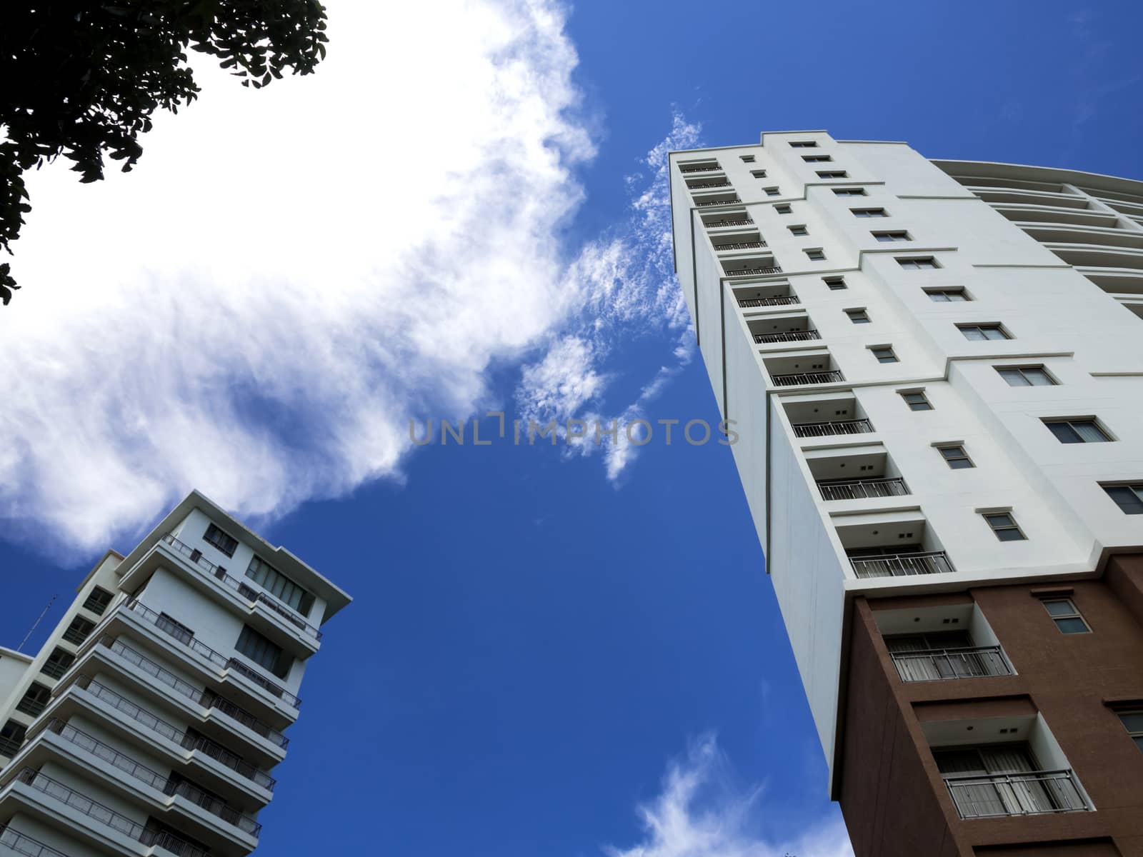 High-rise building and bright blue sky by Satakorn