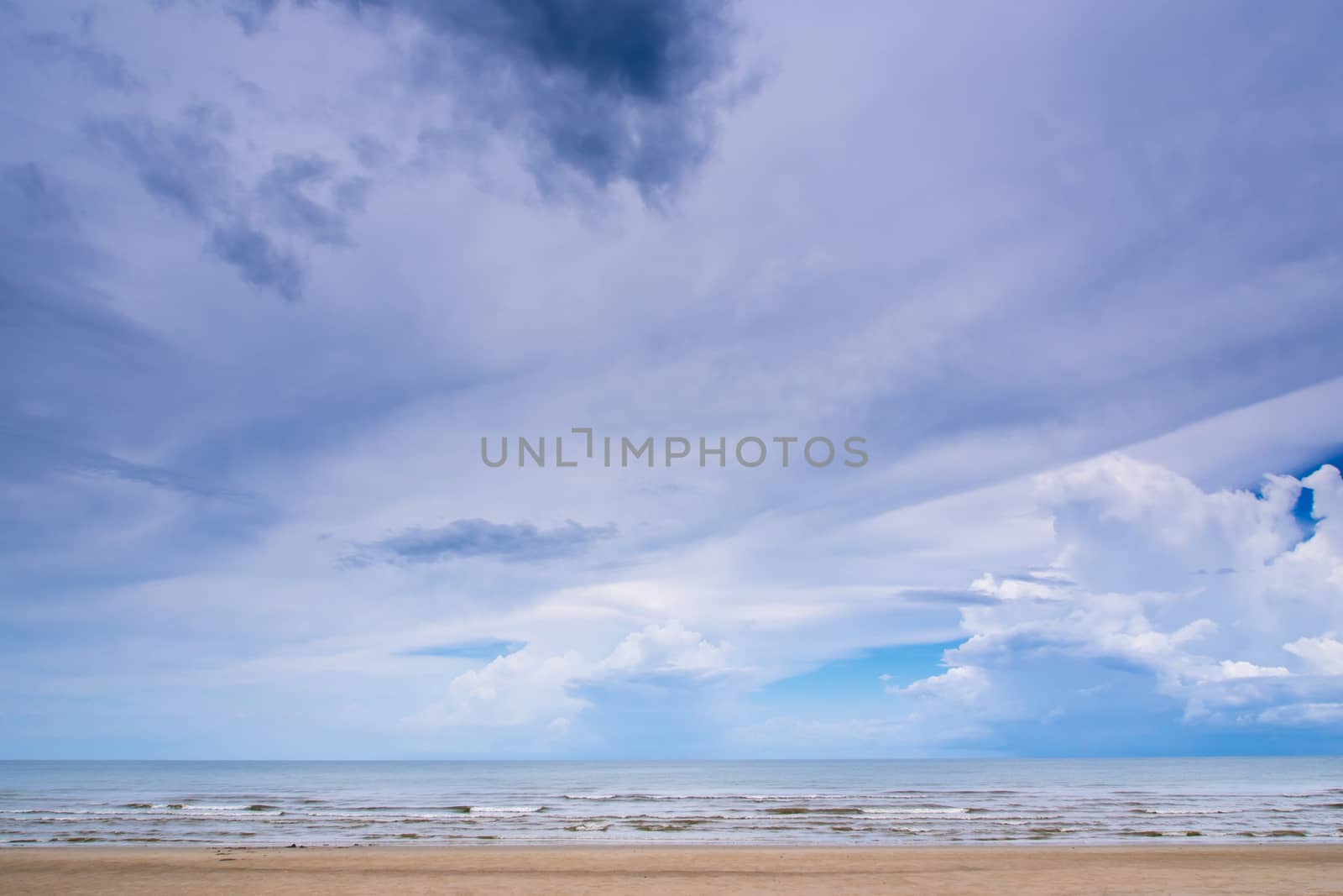 Clouds in the bright blue sky over sea by Satakorn