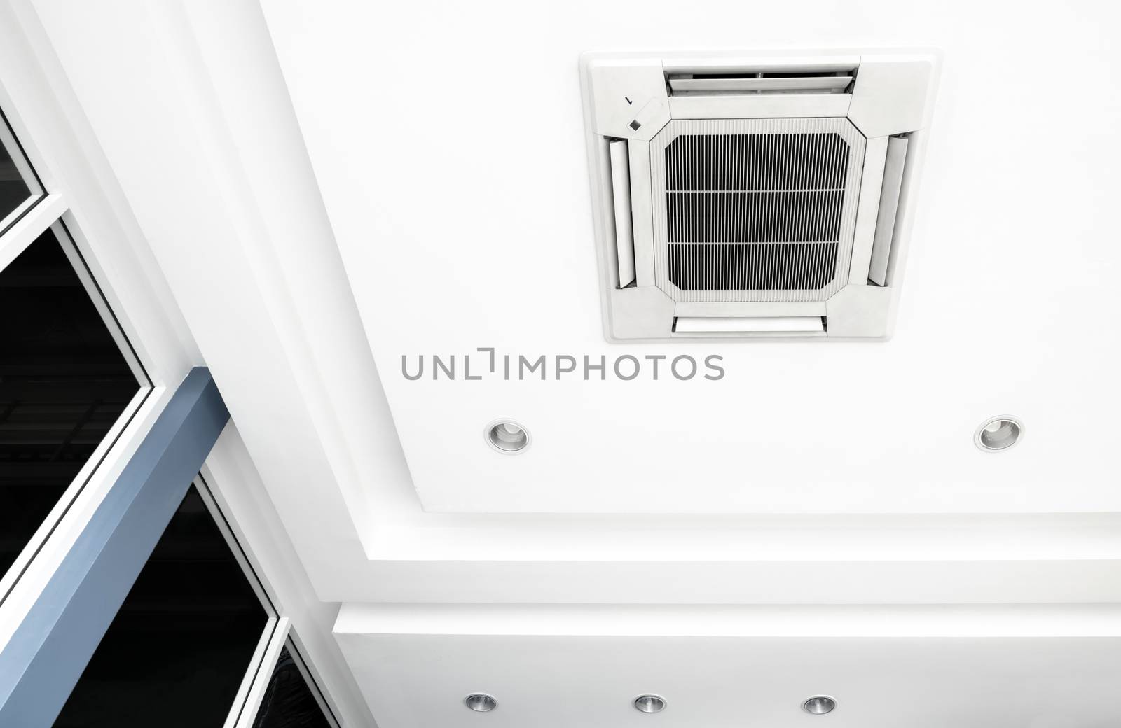 Lighting and ceiling mounted air conditioner on the modern offic by Satakorn