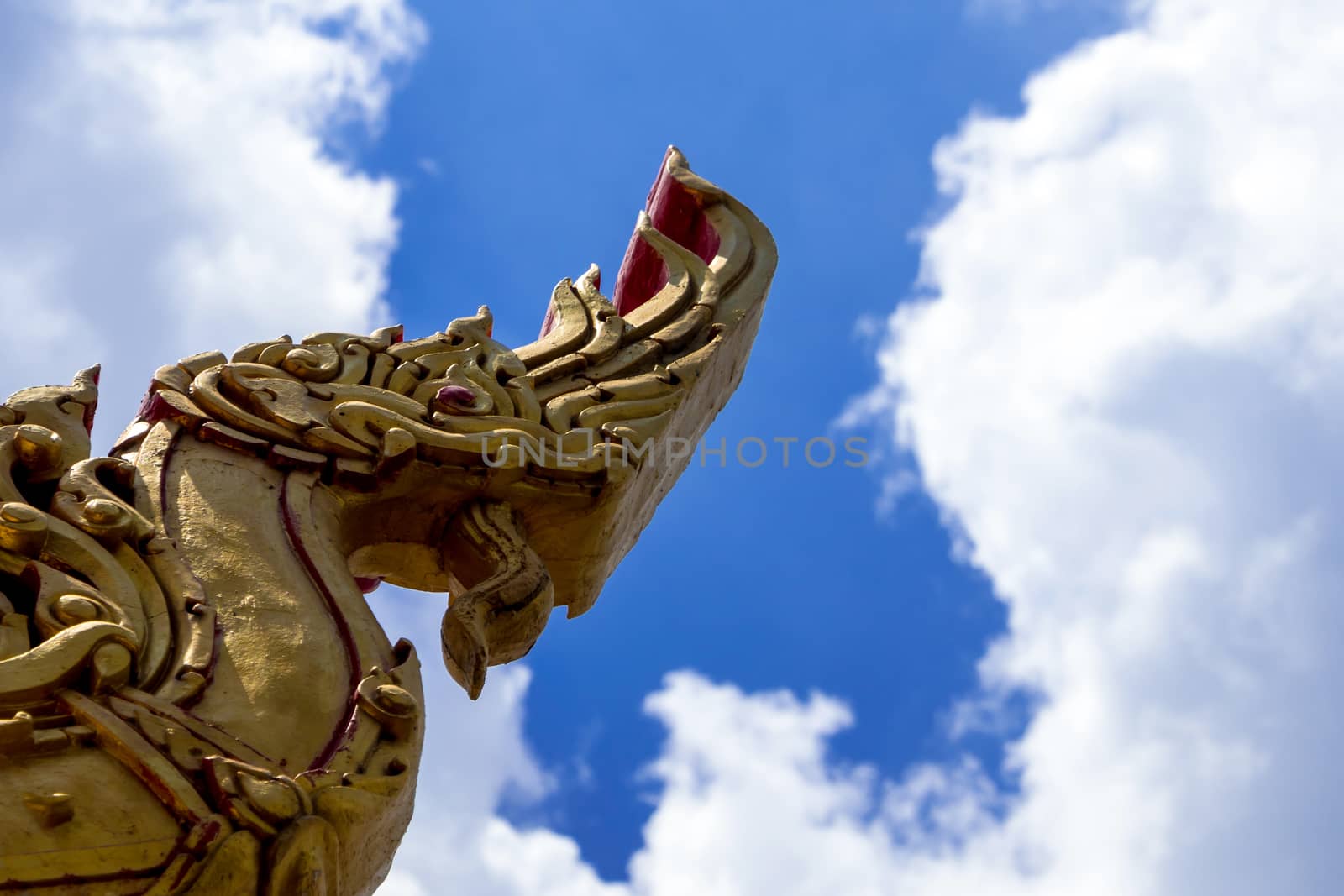 Naga head sculpture Decorate at the roof in Thai temple by Satakorn