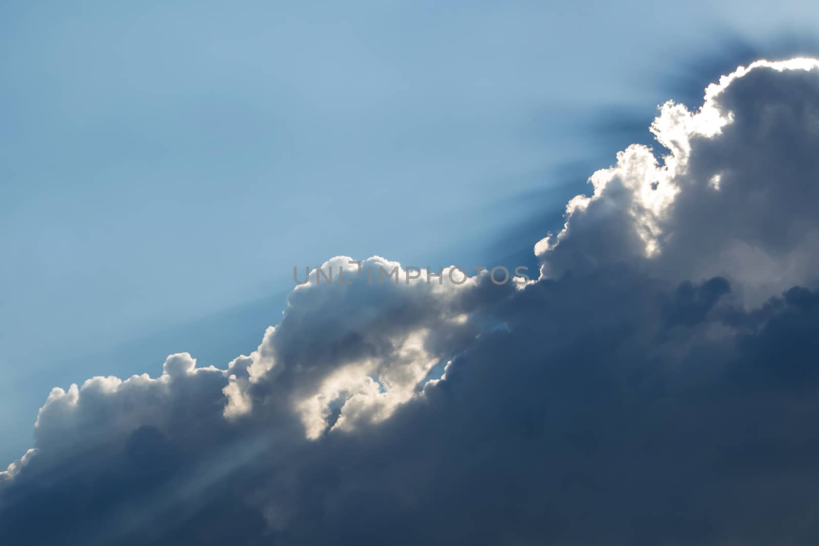 Sunbeam of the sun behind the clouds , sky background