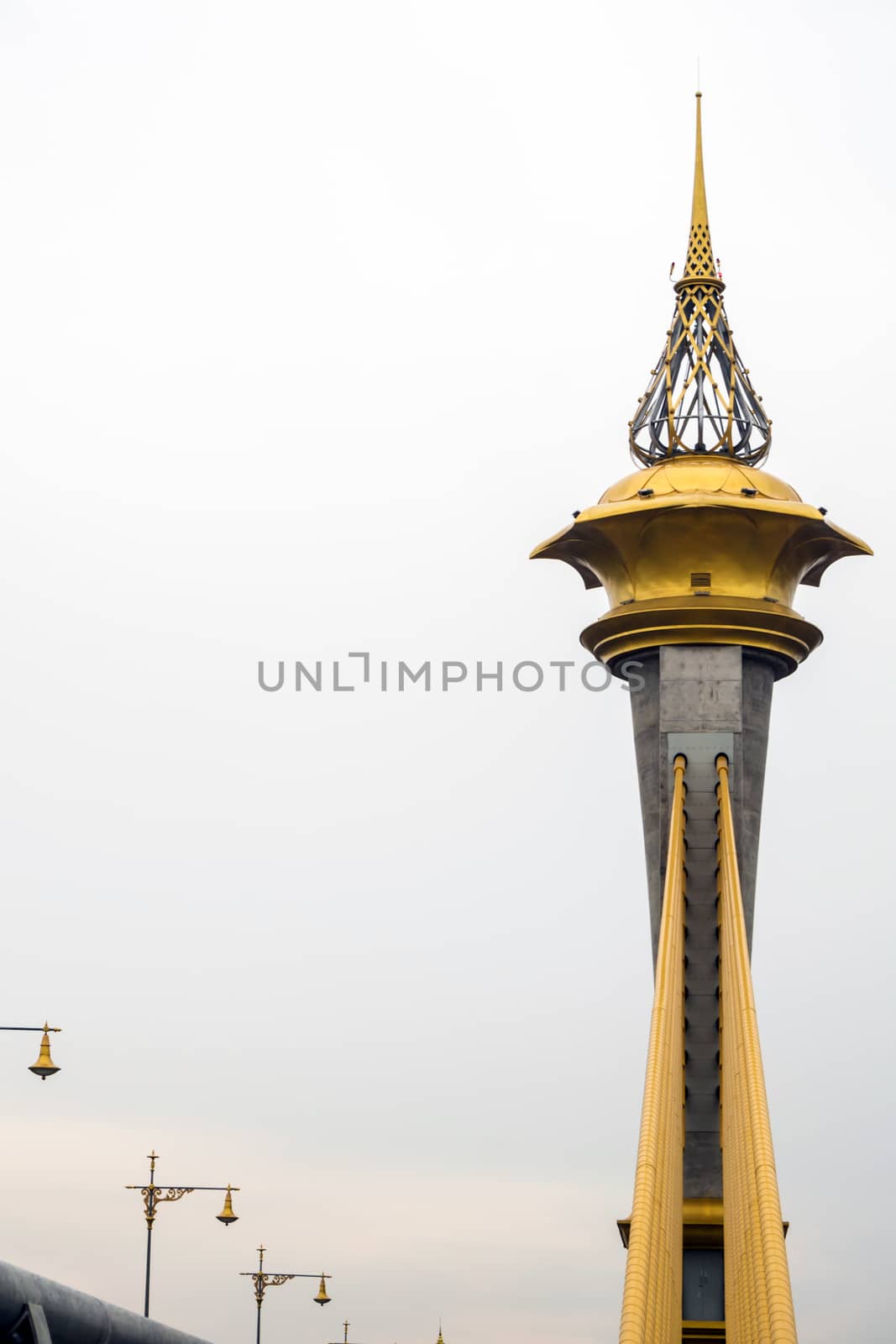 Beautifully decorated structure at the top of the tower of the bridge over the river