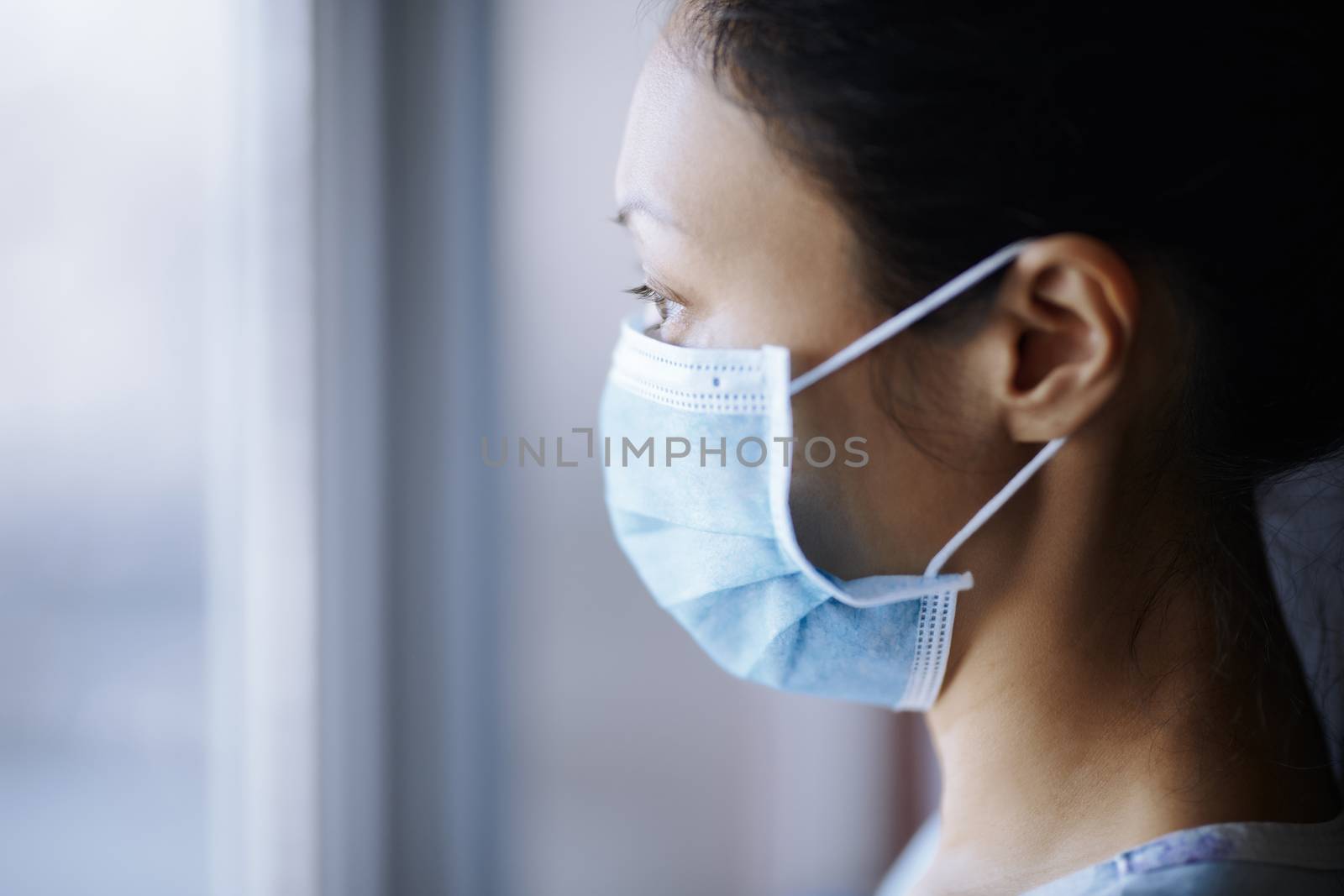 Woman staying at home and wearing protective surgical mask