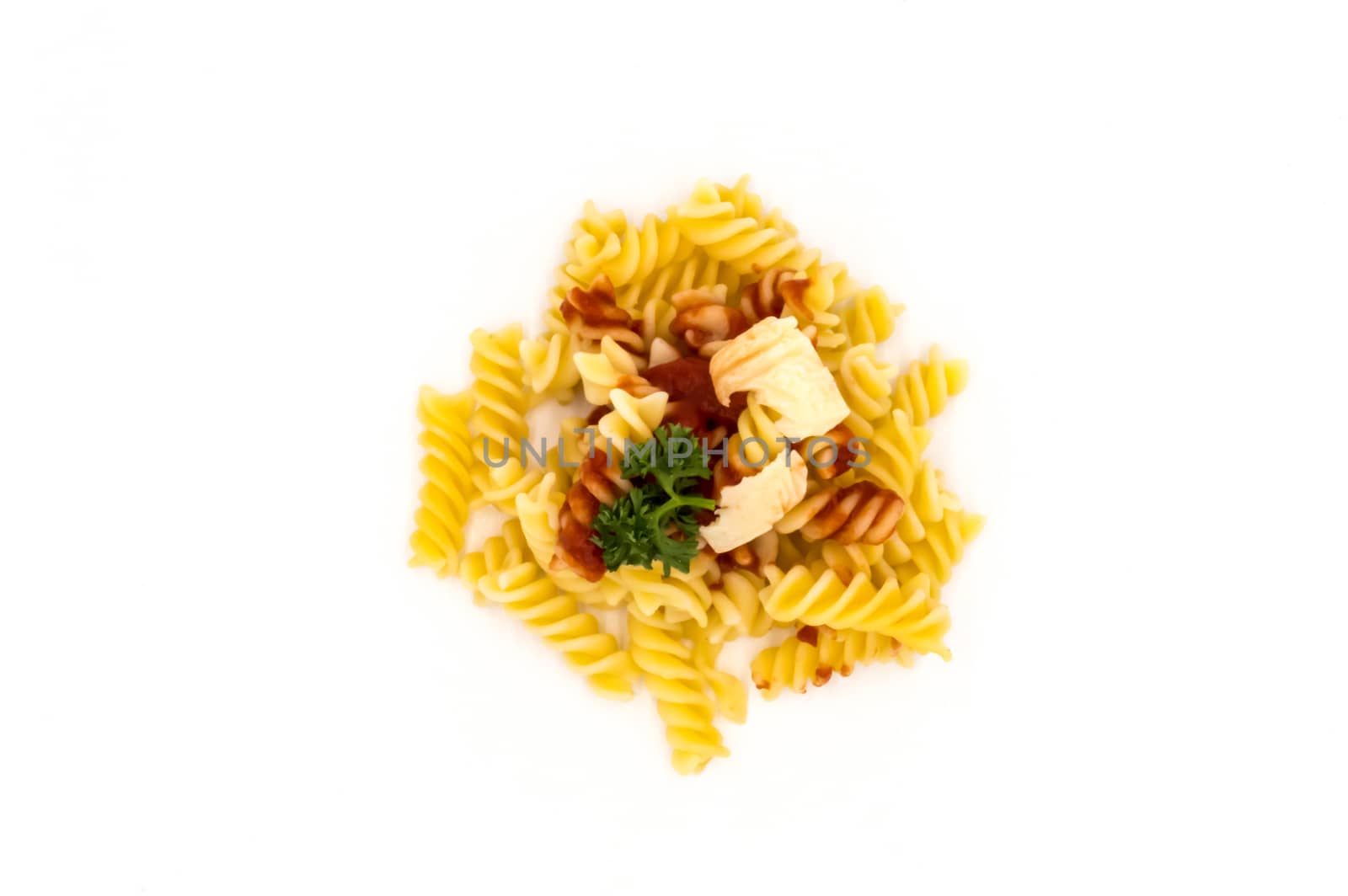Twisted pasta with a tomato coulis and gruyere cheese viewed from above on a white background