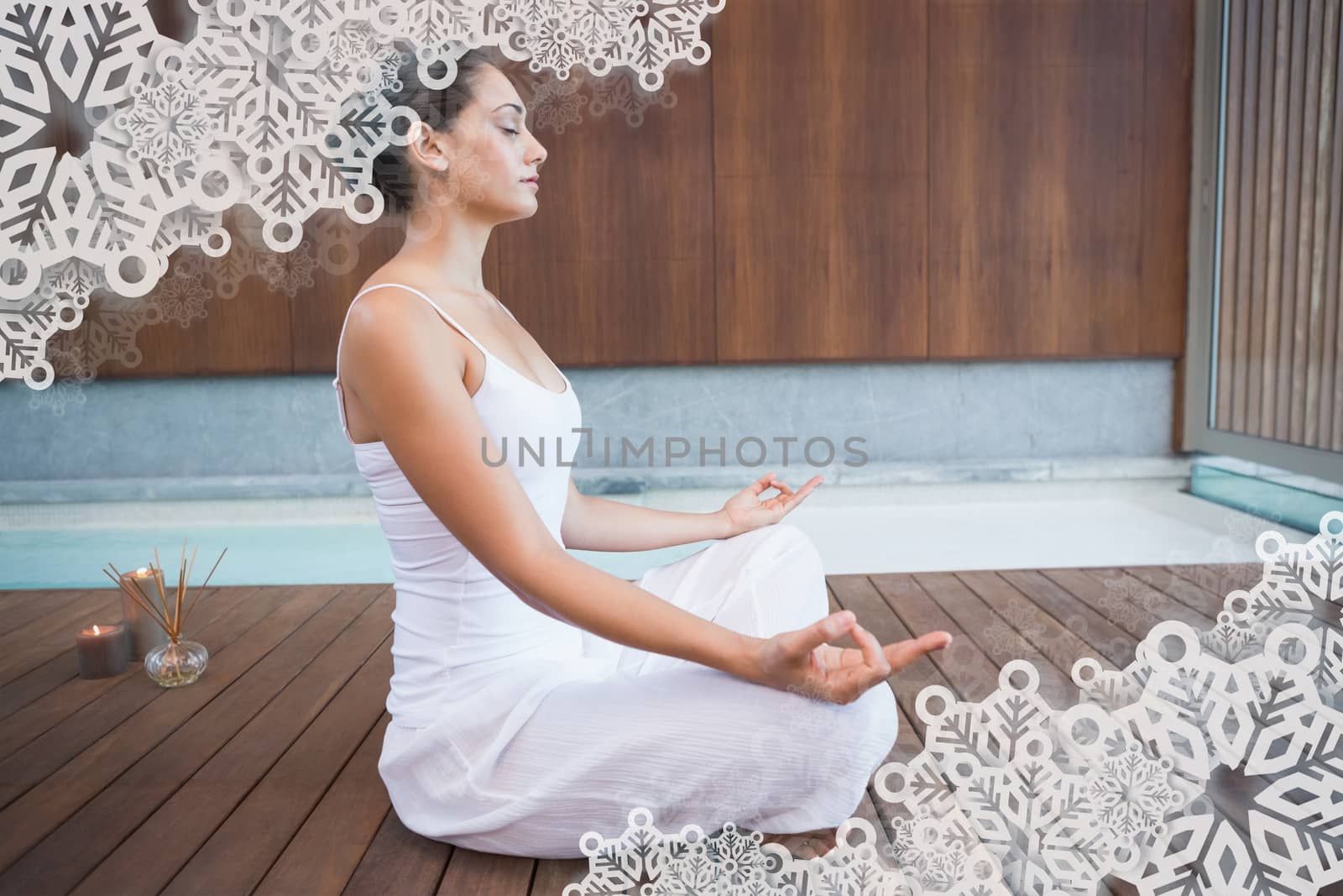 Peaceful brunette in white sitting in lotus pose  by Wavebreakmedia