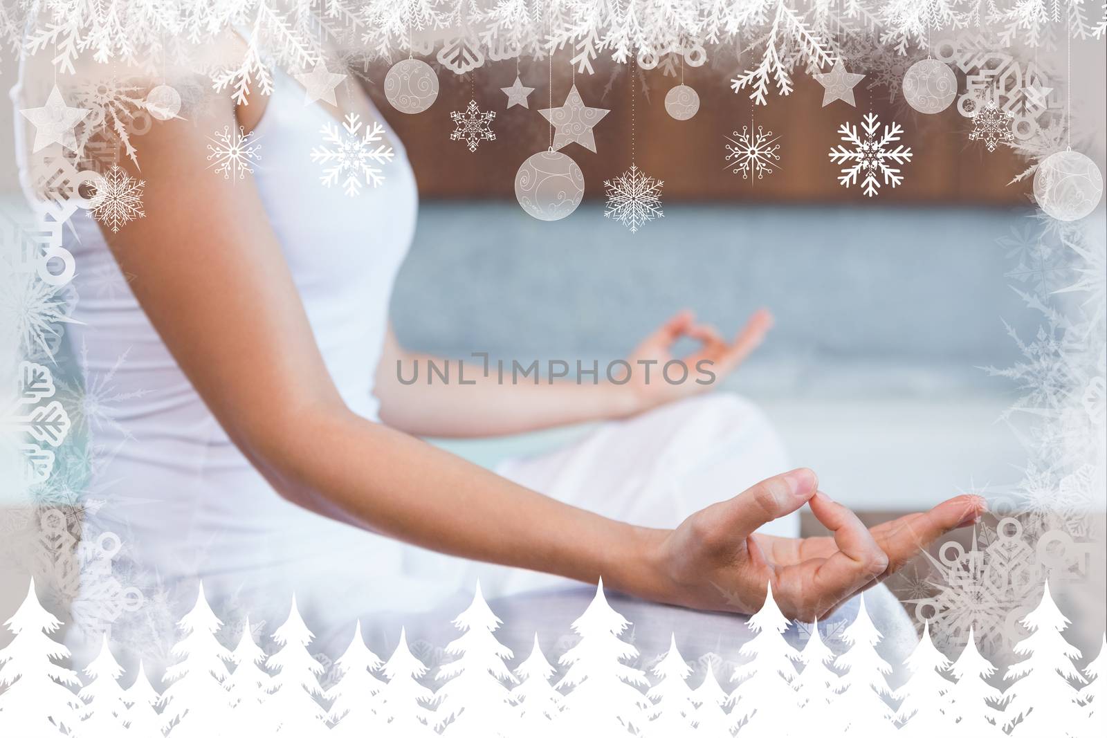 Peaceful woman in white sitting in lotus pose  against fir tree forest and snowflakes