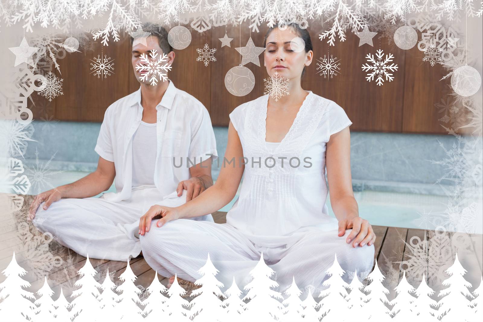 Attractive couple in white sitting in lotus pose against fir tree forest and snowflakes