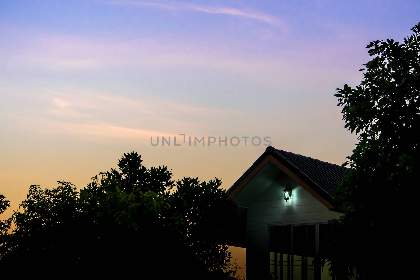 Silhouette of house and tree in the morning by Satakorn