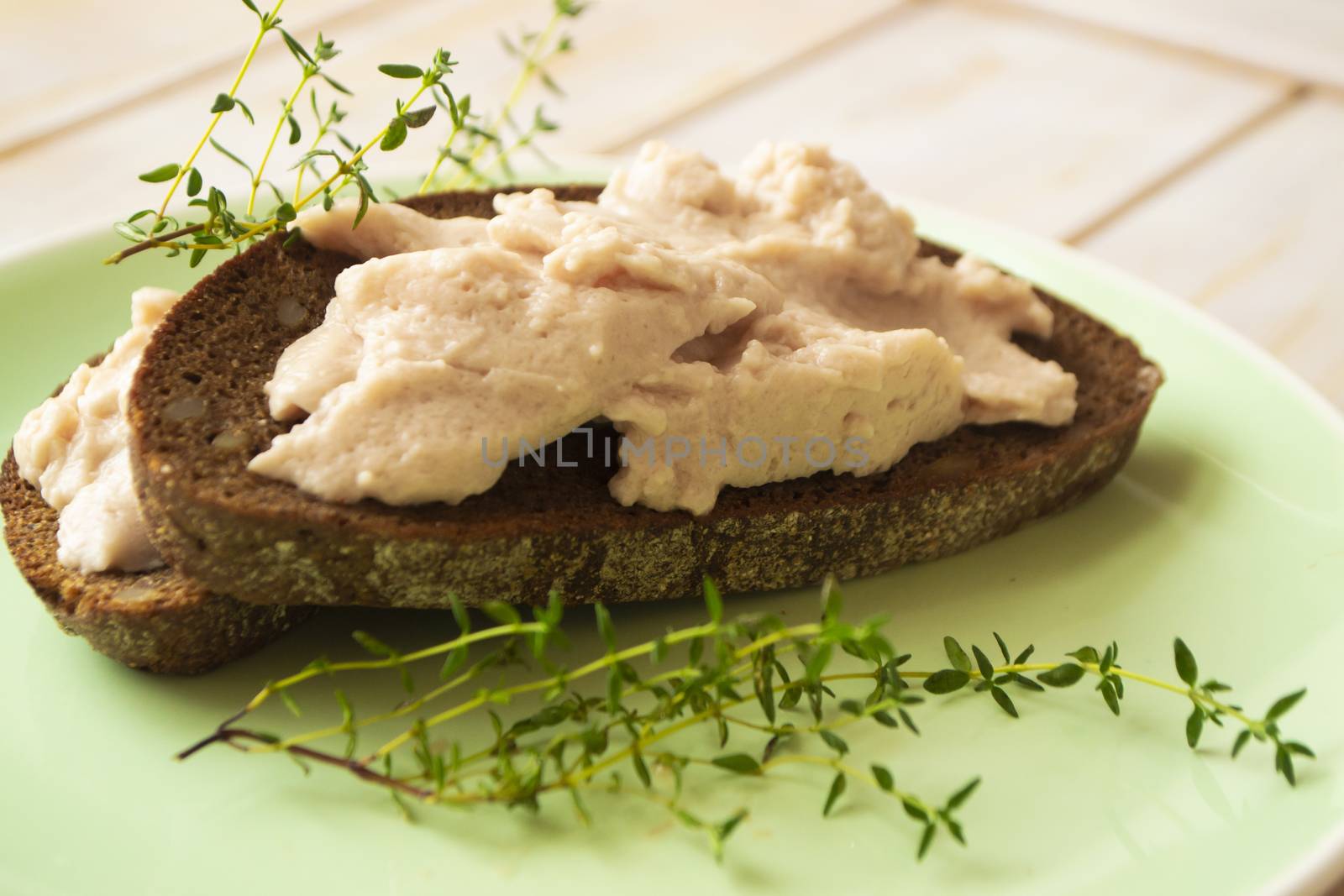 Fresh homemade chicken liver pate on bread in rustic style