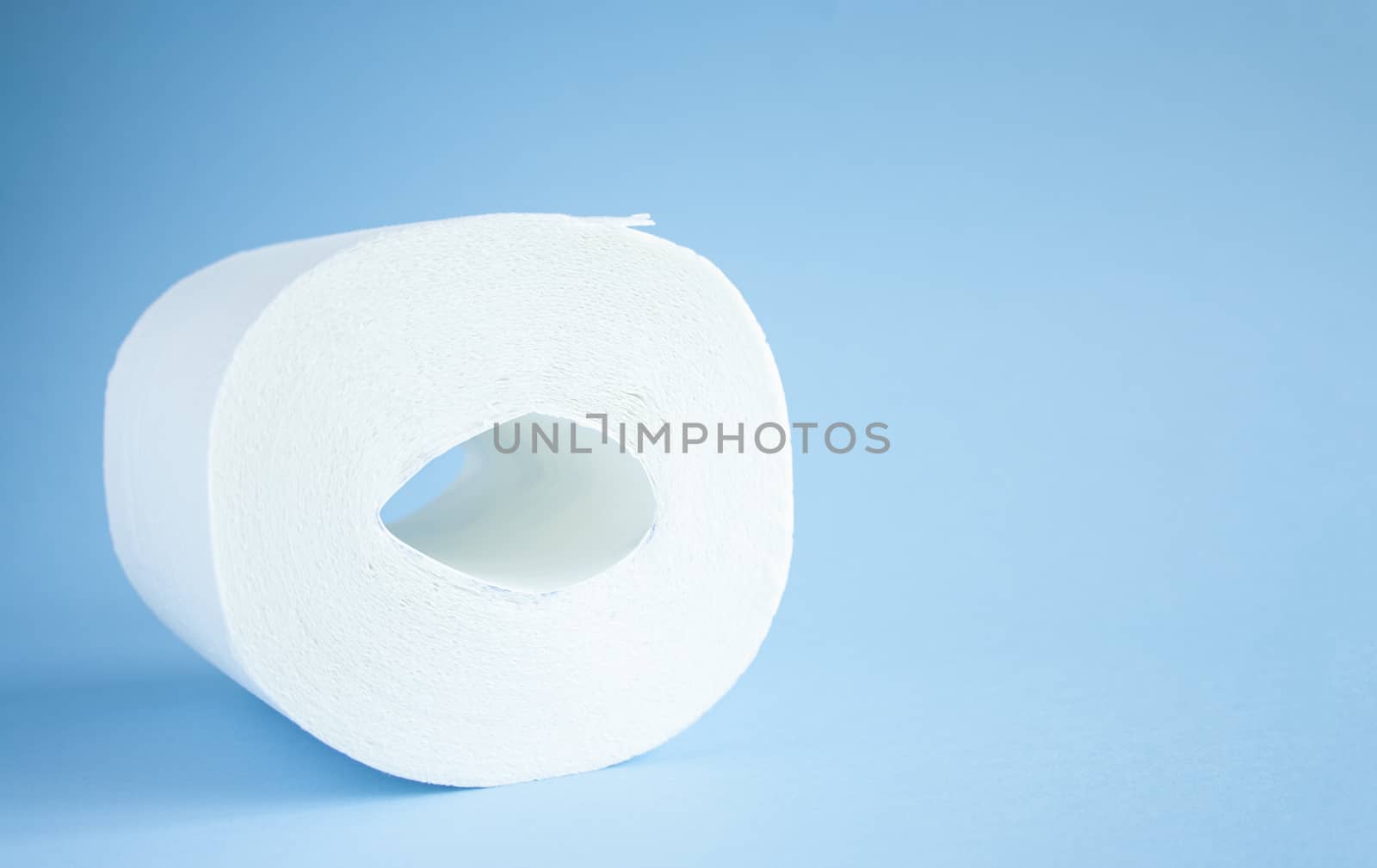 Toilet paper roll on a blue background top view. Toilet paper purchase due to kronavirus concept. Personal hygiene and stopping the spread of the virus. Cleanliness, Hygiene, Sterility copy space