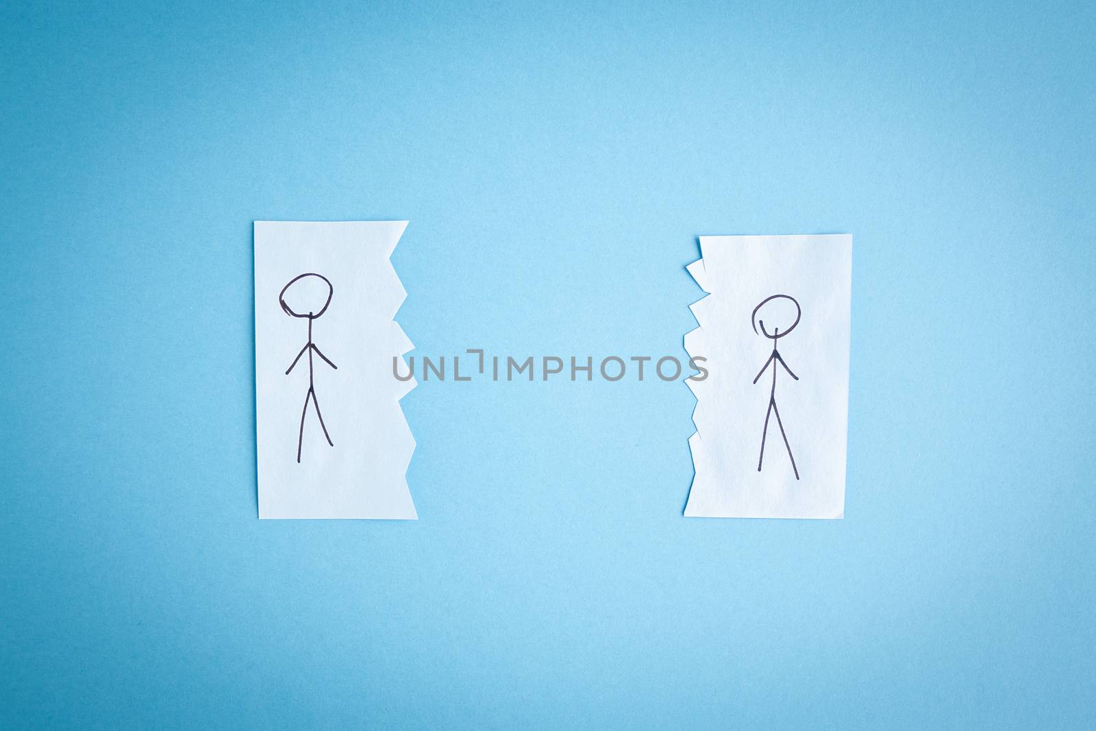 Two people drawn on pieces of paper lie next to each other. The concept of self-isolation. Coronavirus, stop the spread of infection. 2019-ncov