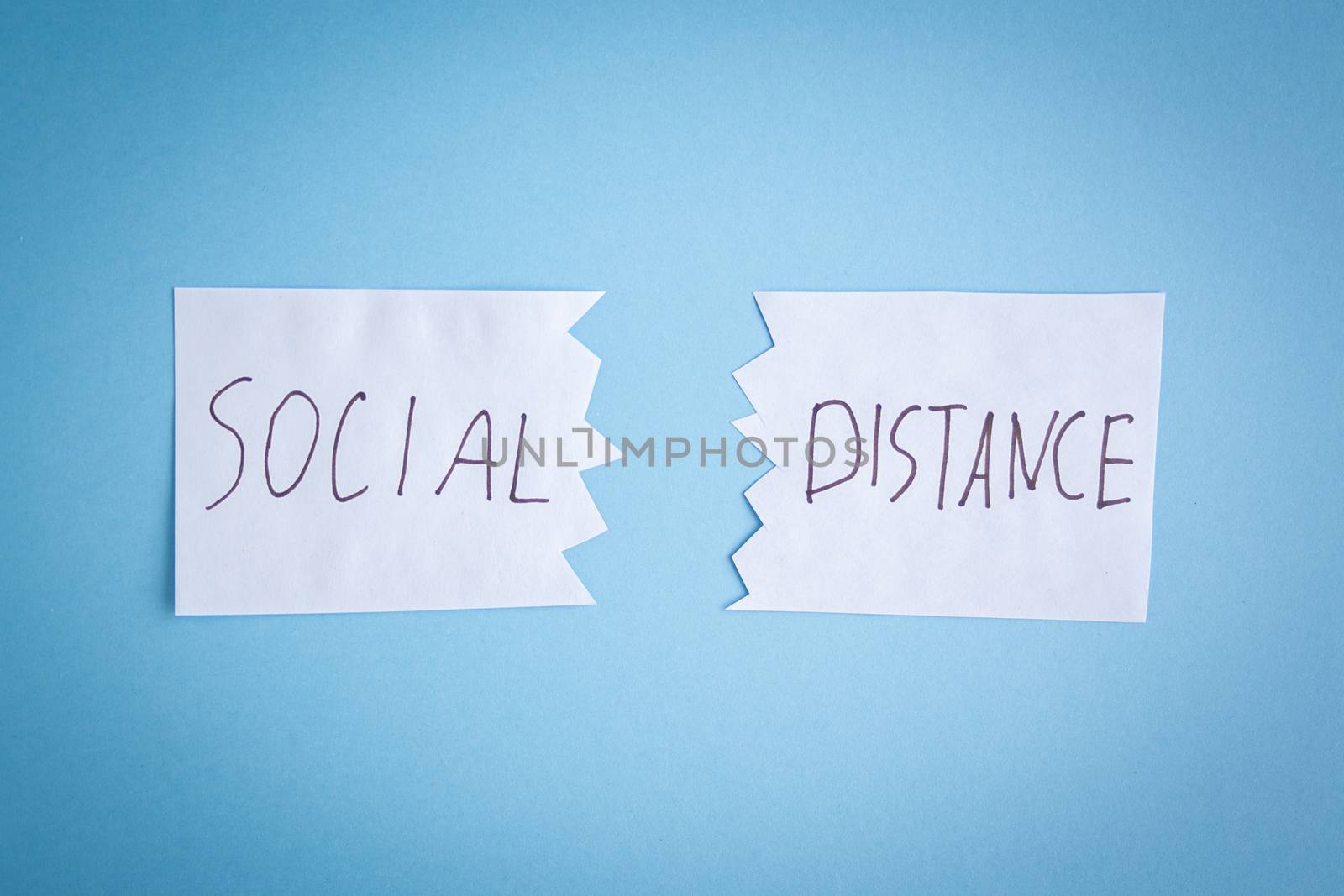 Two pieces of paper lie next to each other with inscription quote social distance. The concept of self-isolation. Coronavirus, stop the spread of infection. 2019-ncov