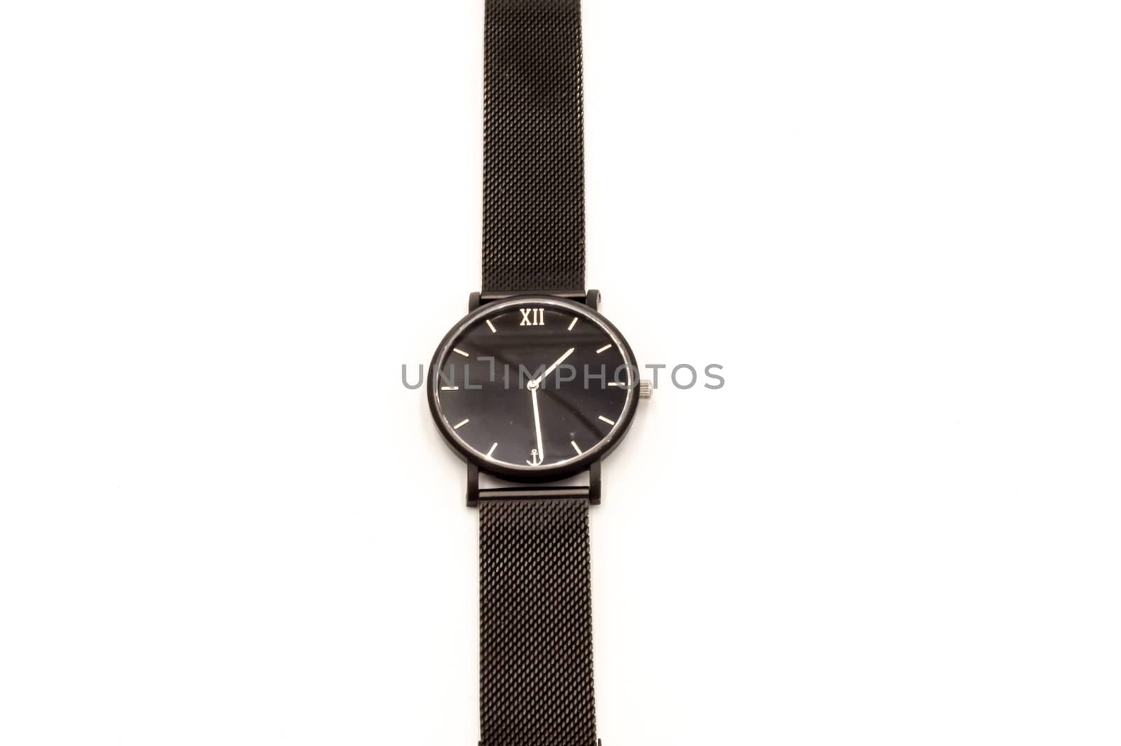 Classic black analog wristwatch on white background, close-up.