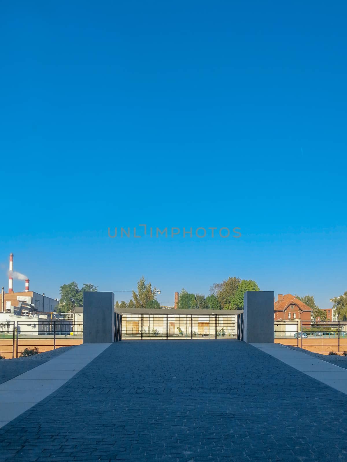 Central bottom look to wooden platform over Odra River with pavement in front of in Wroclaw City at sunny day by Wierzchu