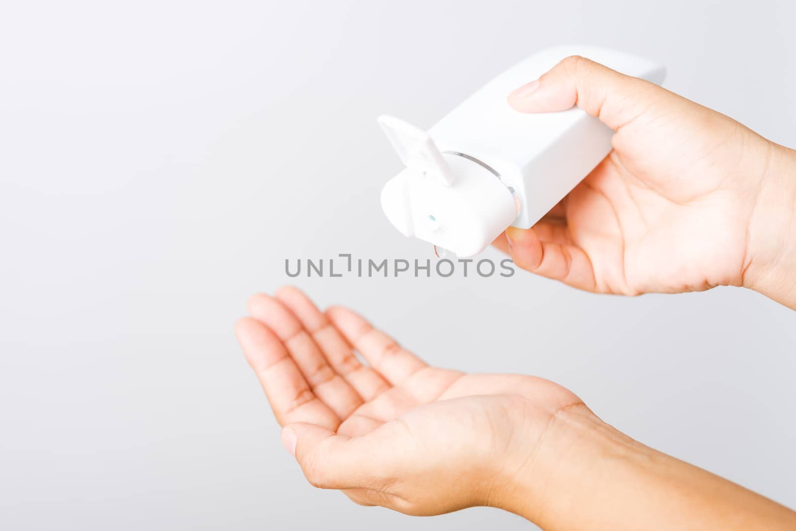 Closeup Hand Asian young woman applying drop dispenser sanitizer alcohol gel on hand wash cleaning, hygiene prevention COVID-19 or coronavirus protection concept, isolated on white background