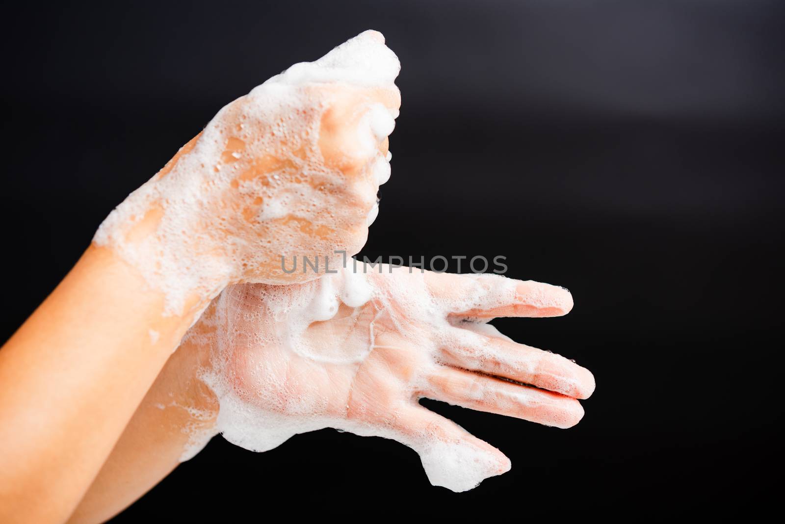 Closeup body care Asian young woman washing hands with soap have foam, hygiene prevention COVID-19 or coronavirus protection concept, isolated on black background