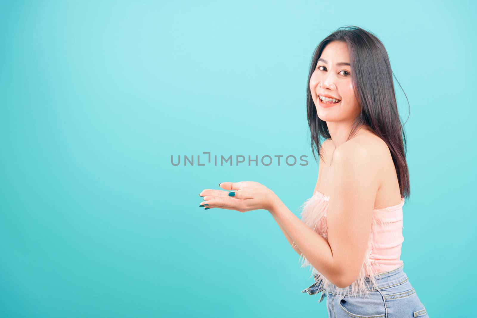 Smiling face Asian beautiful woman her showing holding something by Sorapop