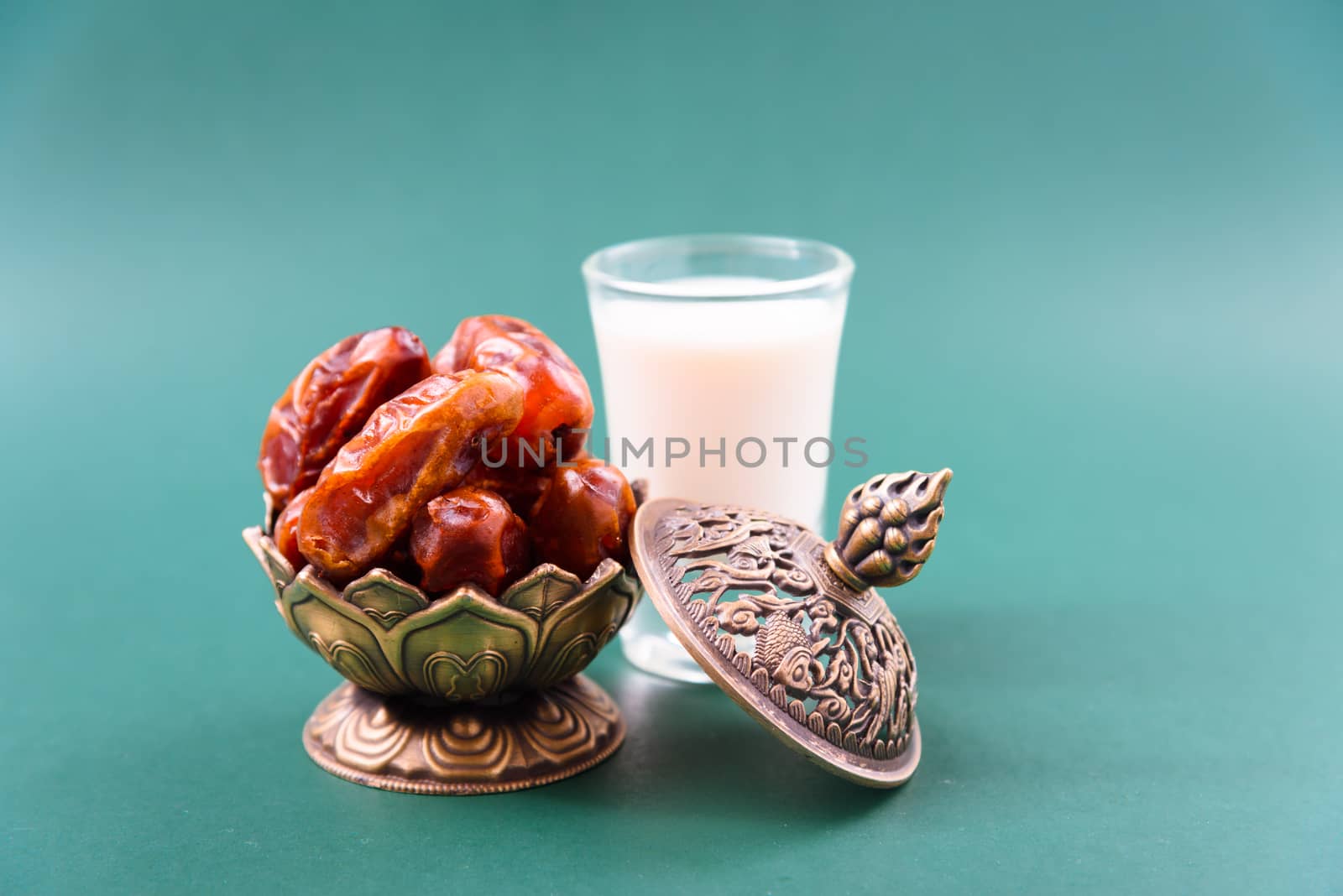 Ramadan, Dates in golden bowl, Milk, arabian Aladdin golden lamp vintage style on black green background