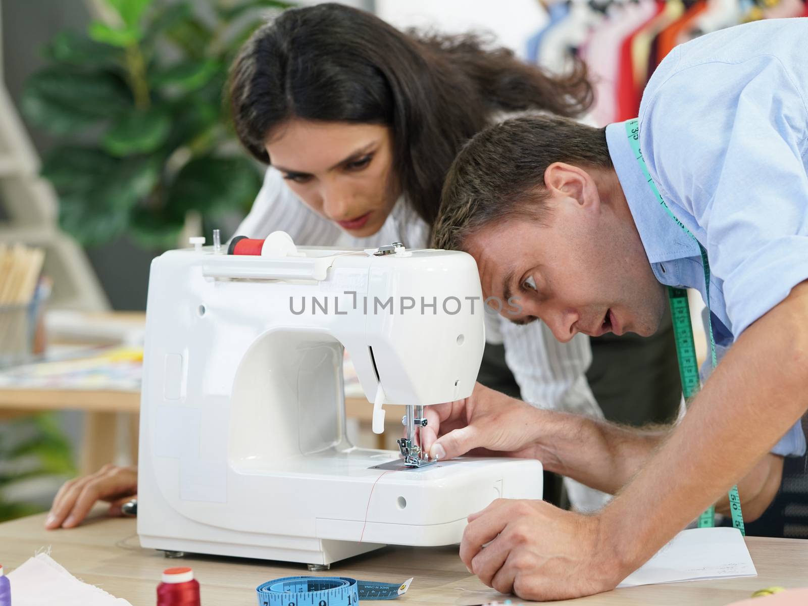 Fashion designer room, The tailor is checking the authenticity of the sewing machine. Before starting to work for customers who are waiting.