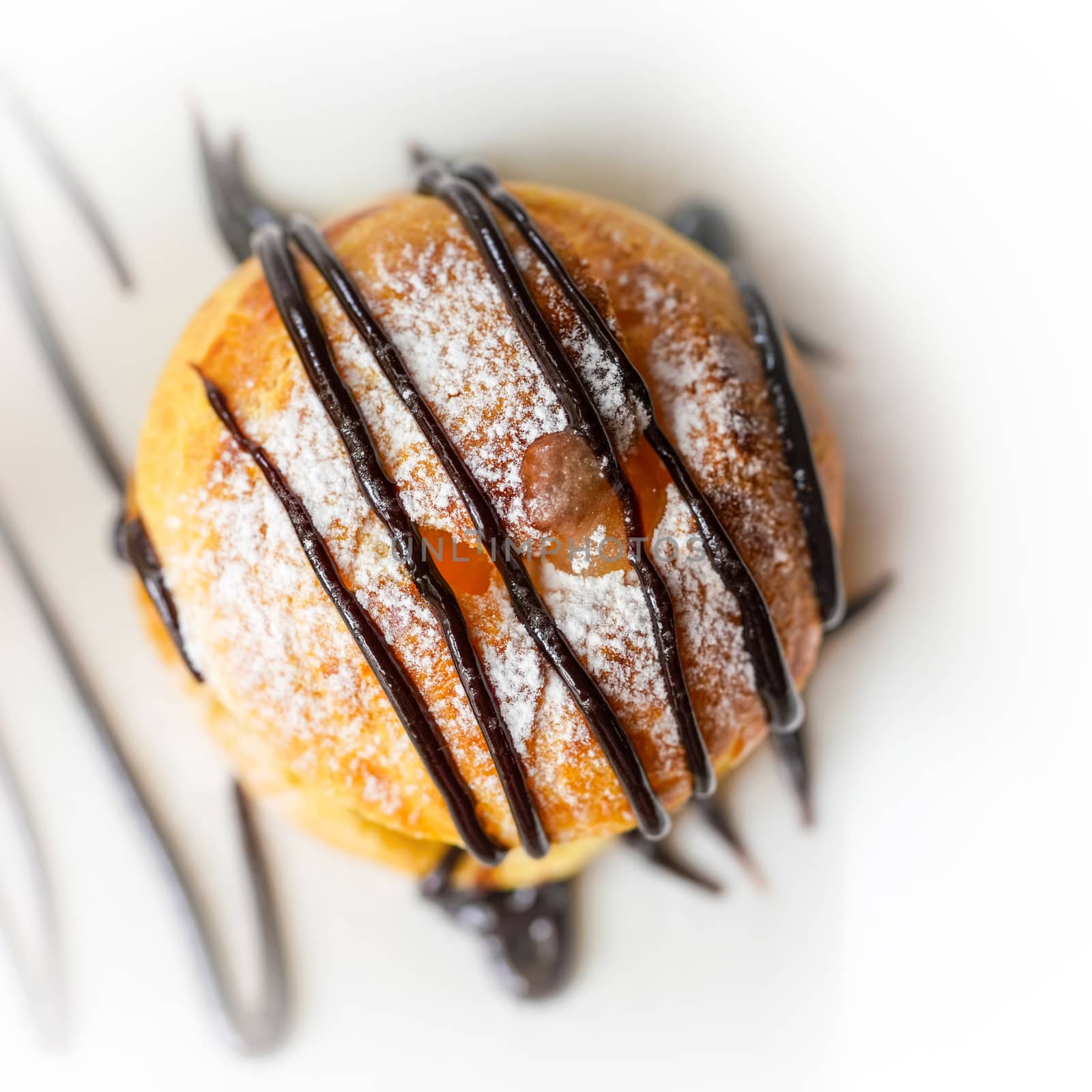 Profiterole, a filled French choux pastry ball with a typically sweet and moist filling of Vanilla Ice Cream, Salted Caramel, Chocolate Sauce
