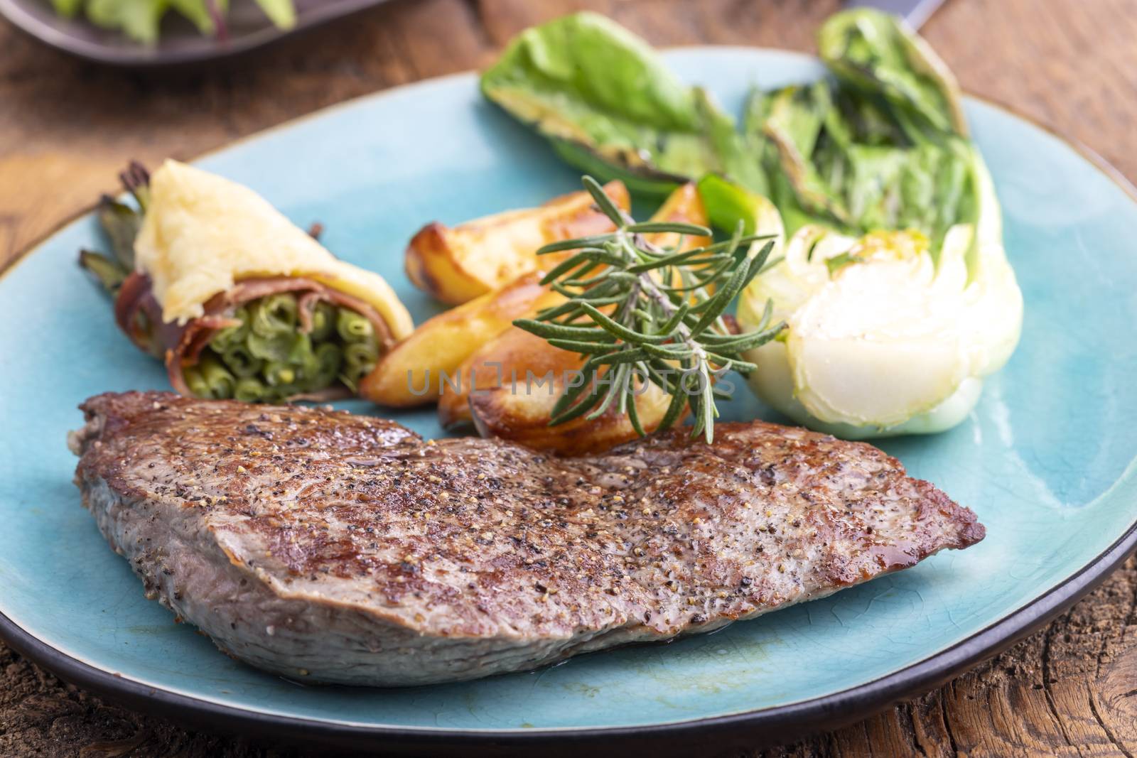 steak on a plate with vegetables